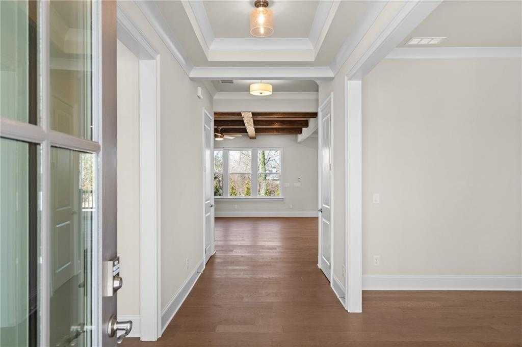Elegant entry foyer with beamed ceiling, hardwood floors, and natural light in 5-bedroom Davidson Homes Arlington A, East Cobb, Georgia