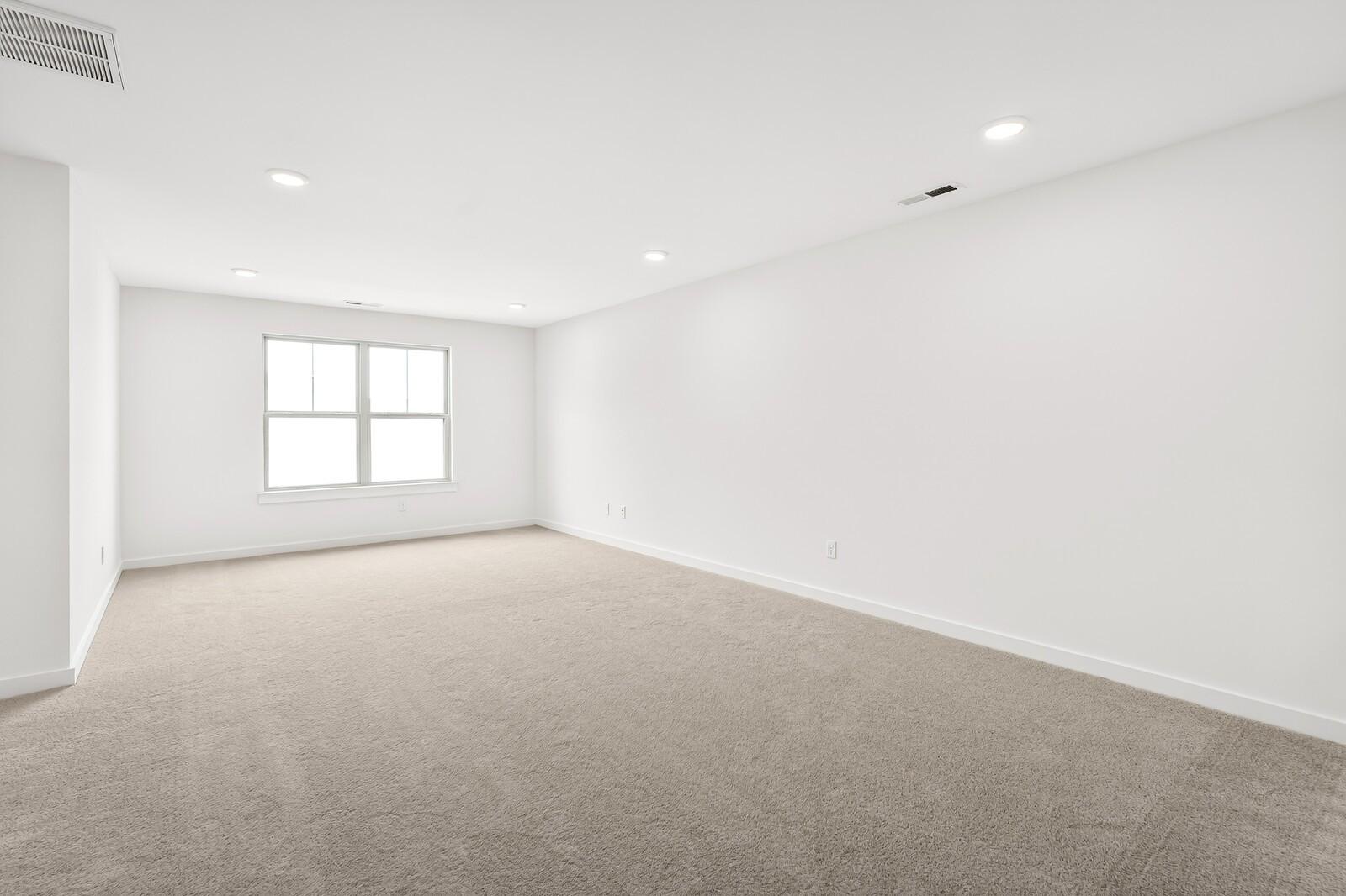 Spacious empty bedroom with beige carpet, white walls, double window, and recessed lights in 5-bed Ridgeport C home, Gallatin, TN