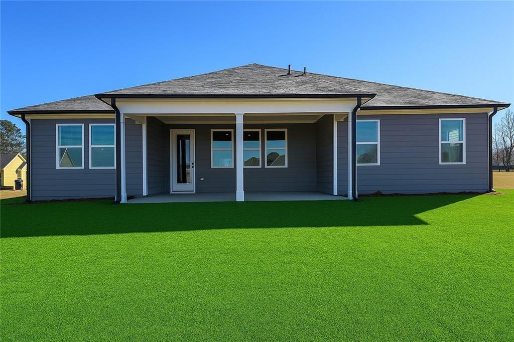 Covered back patio with white columns, glass doors, and large windows on gray-sided 1-story home in Wehunt Meadows, Hoschton, Georgia