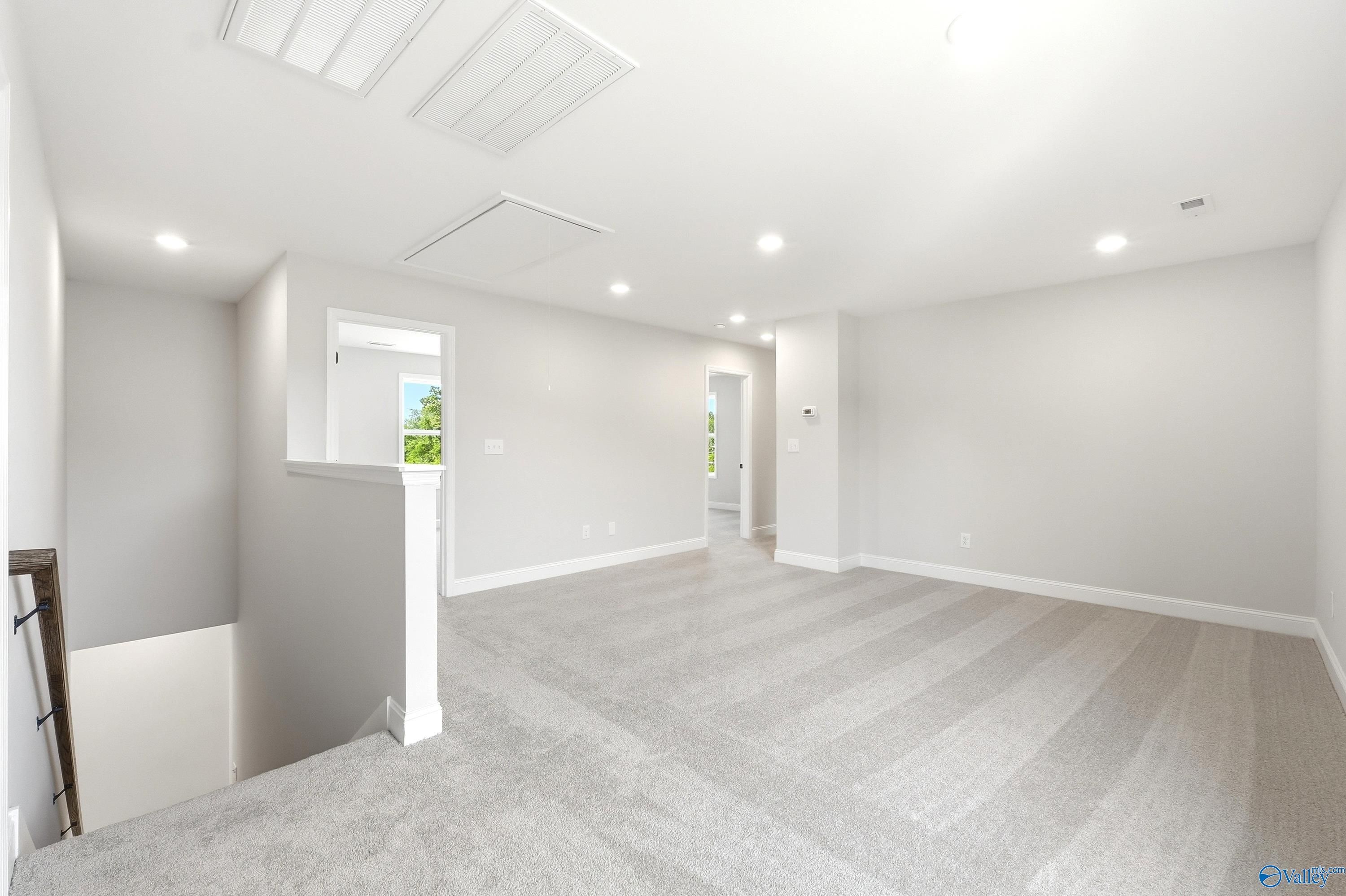 Spacious carpeted loft area in The Russell A floor plan by Davidson Homes in Spragins Cove, Huntsville, Alabama.