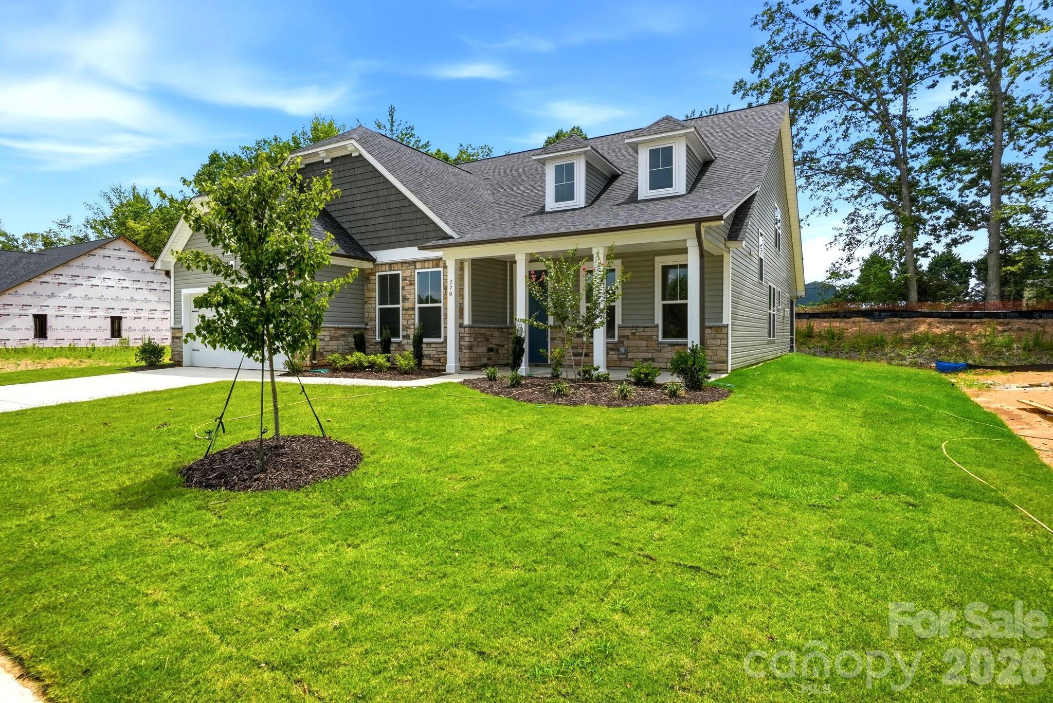 The Magnolia B floor plan by Davidson Homes in Windgate, Mooresville, NC, featuring a 1.5-story exterior and 2-car garage.