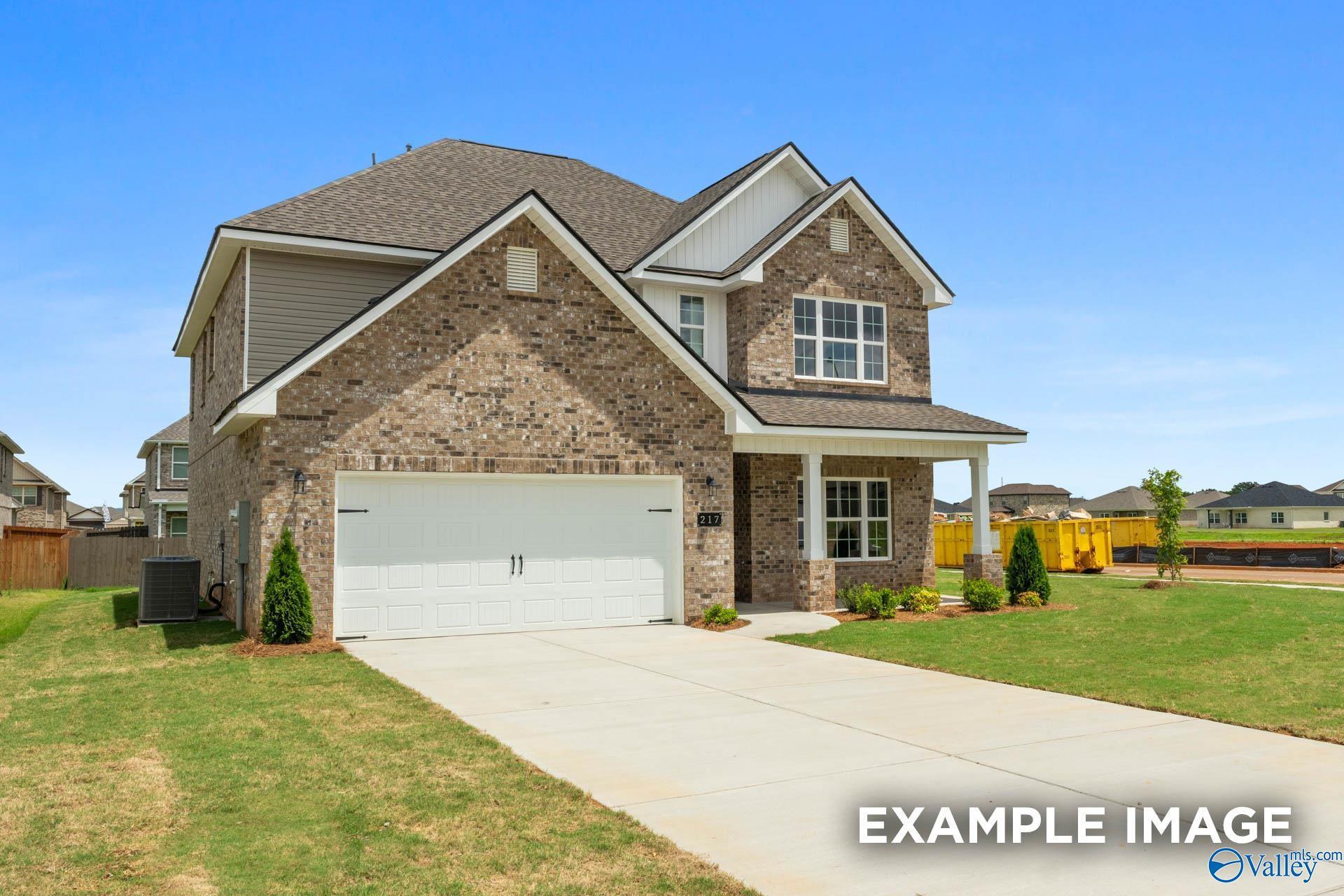 Modern two-story brick home with 2-car garage, driveway, and landscaped yard in Ivy Hills, Toney, Alabama by Davidson Homes