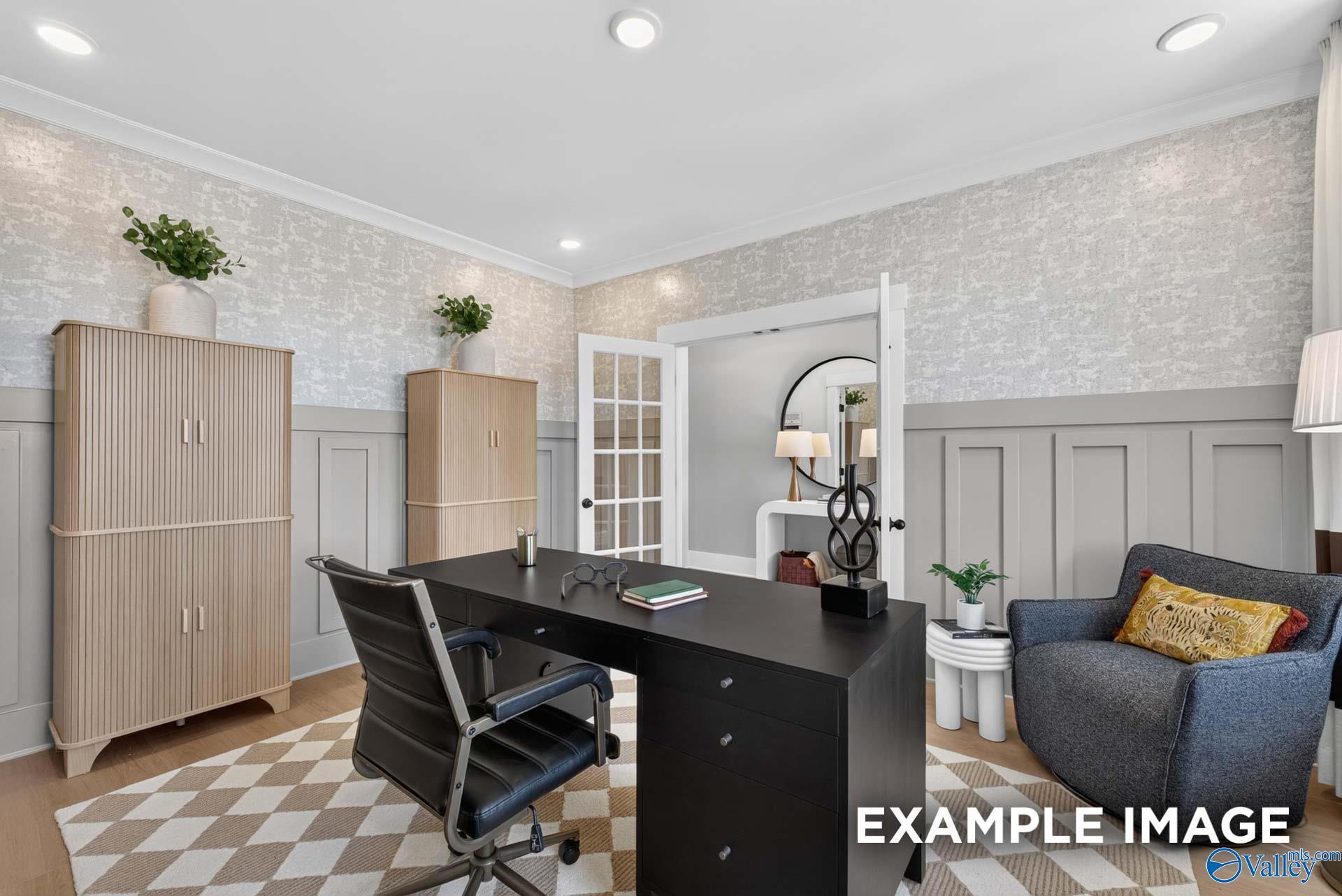 Elegant home office with black desk, wainscoting walls, and French doors in Davidson Homes Ashport K plan, Hazel Green, Alabama