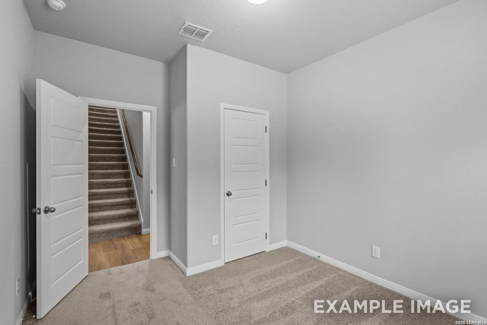 Bedroom with neutral carpet and closet in The Gillian A floor plan at Cedar Heights, San Antonio, Texas.