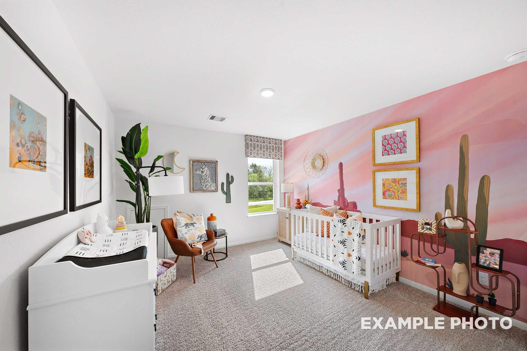 Charming nursery with pink desert cactus mural, white crib, changing table in Davidson Homes The Sabine F, Magnolia, Texas