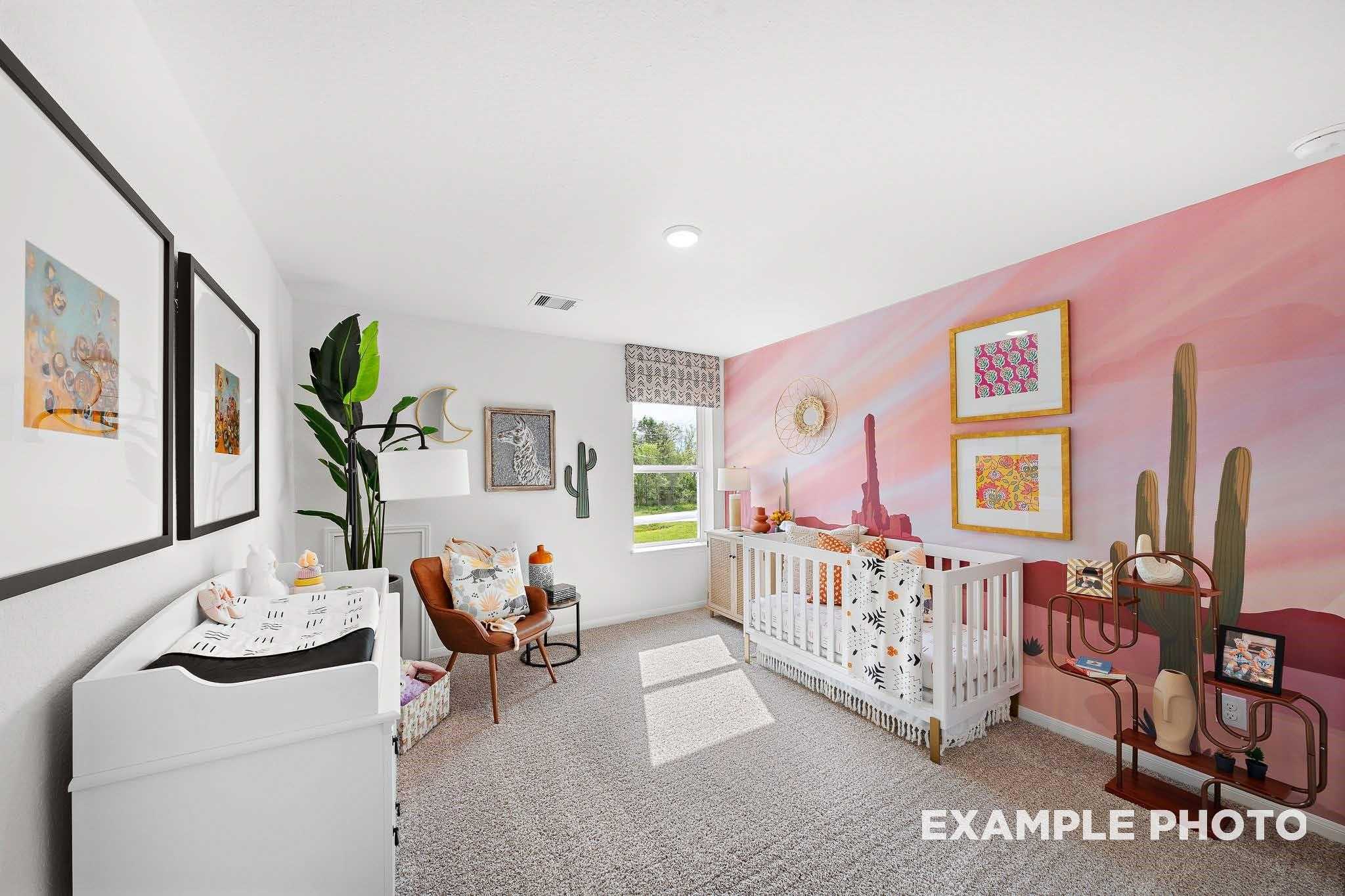 Charming nursery with pink desert cactus mural, white crib, changing table in Davidson Homes The Sabine F, Magnolia, Texas