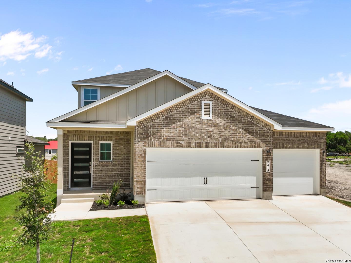 Two-story brick exterior of The San Marcos F floor plan by Davidson Homes with 3-car garage in Rayburn Valley, San Antonio.