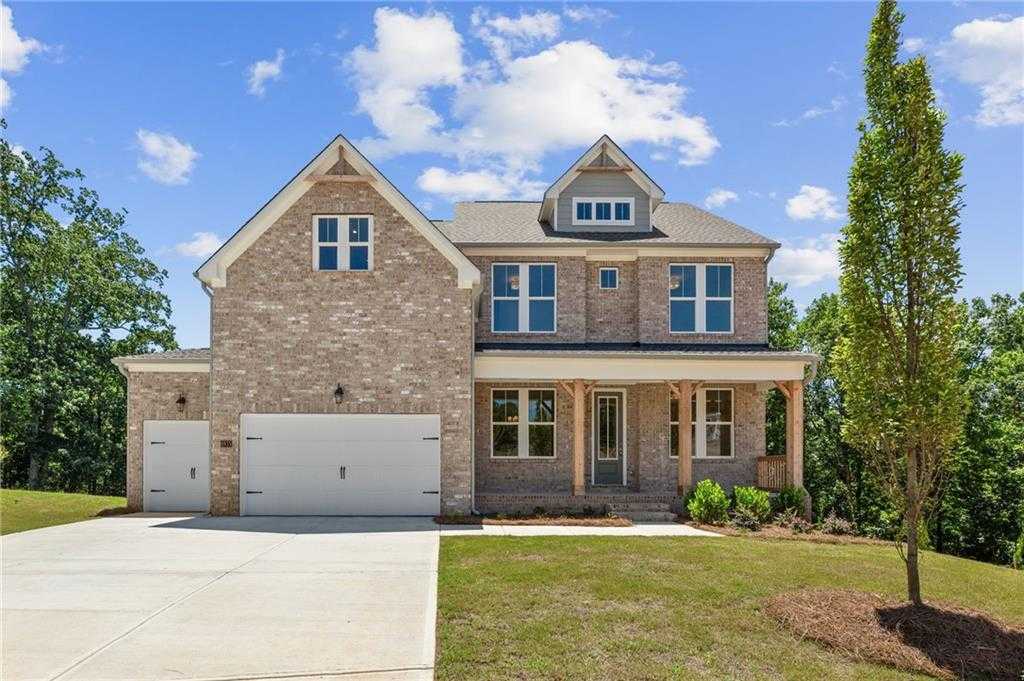 Two-story brick home with 3-car garage, covered porch, and lush landscaping in Melody Lakeside Estates, Buford, Georgia - Davidson Homes The Hampton C