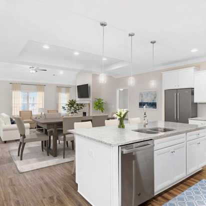 Spacious open-concept kitchen dining living area at Huntington Park in Priceville Alabama with white island hardwood floors