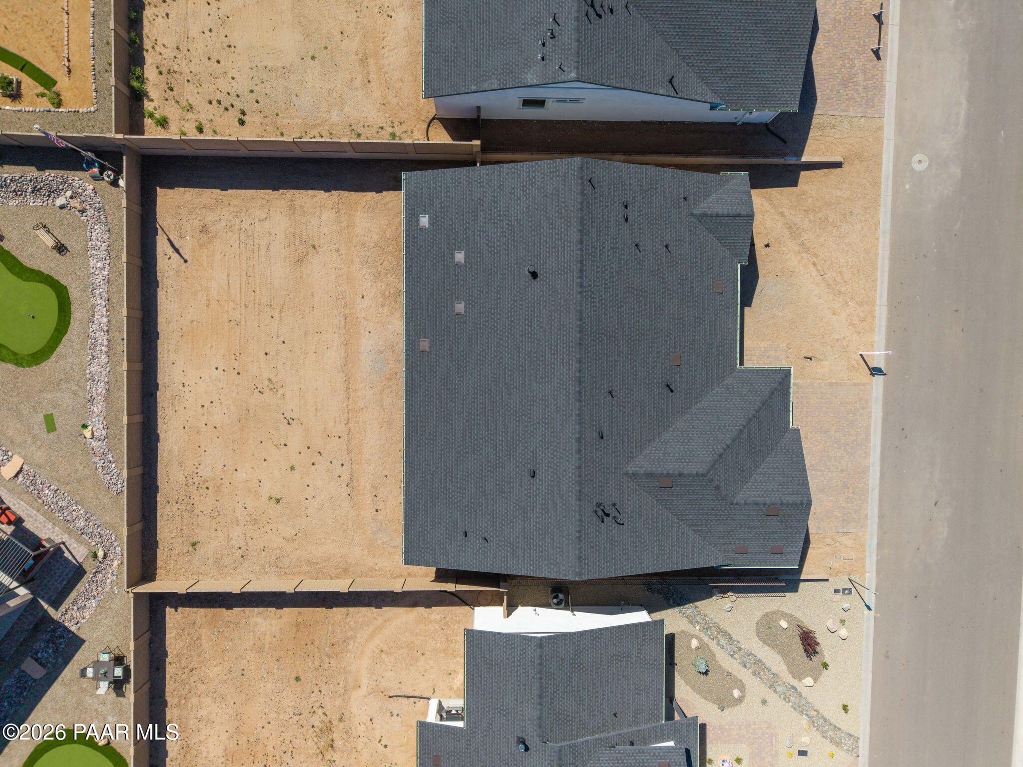 Aerial view of The Monarch A 3-bedroom single-story home by Davidson Homes in Westwood, Prescott, Arizona, with dark shingle roof and putting green yard