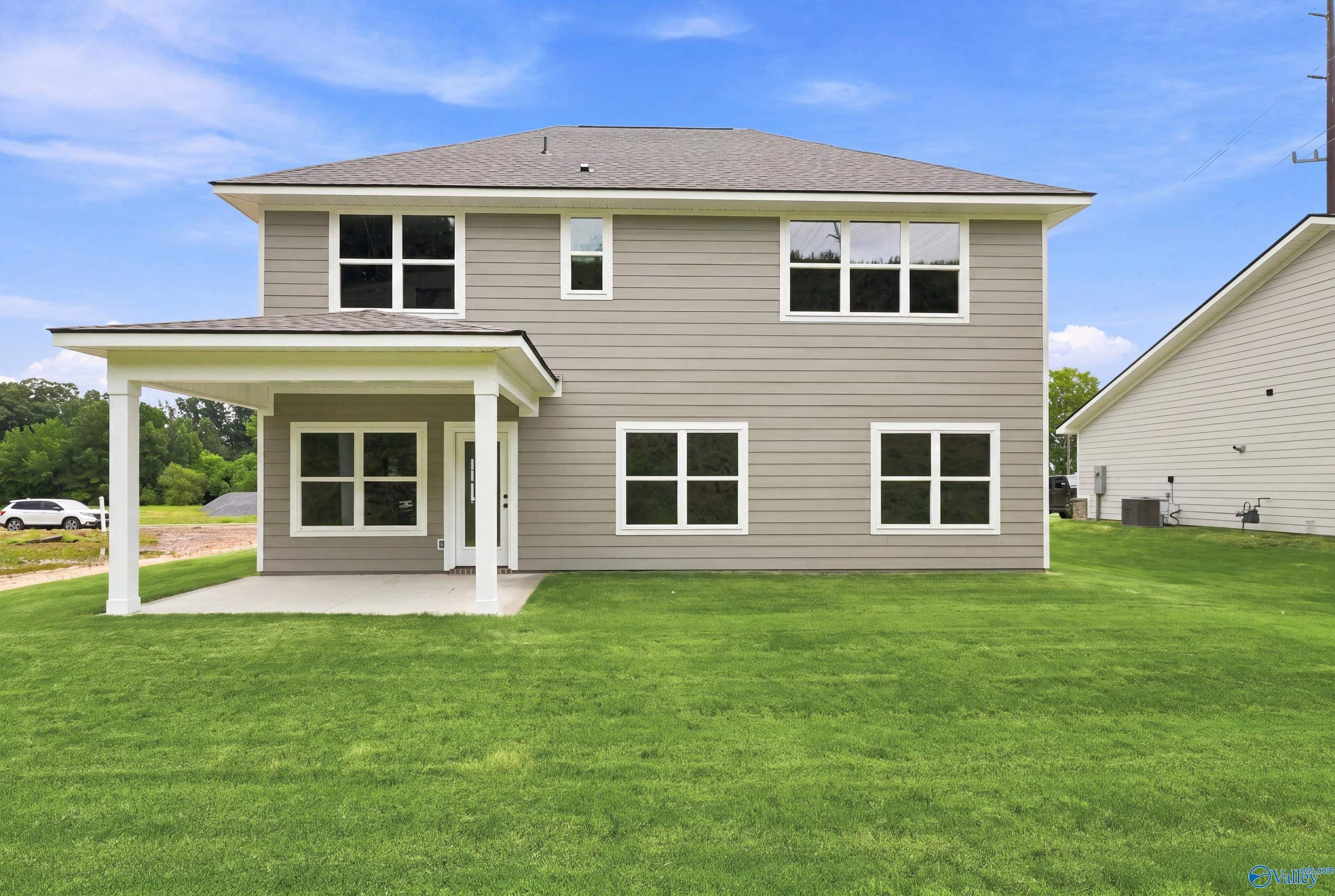 Rear exterior view of The Shelby D floor plan by Davidson Homes featuring a covered patio in Noble Ridge, Cullman, Alabama.