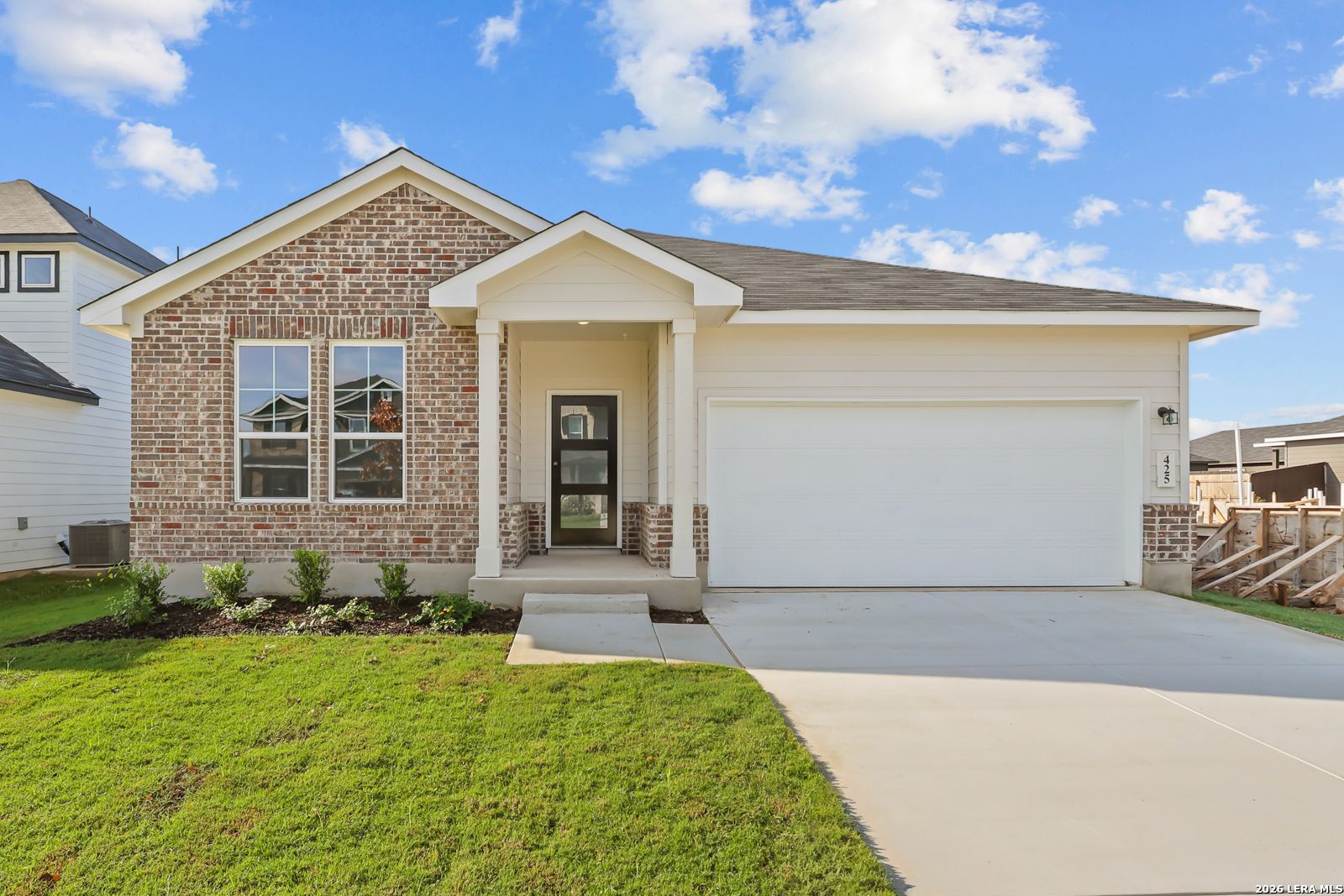 Brick and siding exterior of Davidson Homes' Daphne H plan, a 4-bed, 2-car garage home in Hannah Heights, Seguin, Texas.