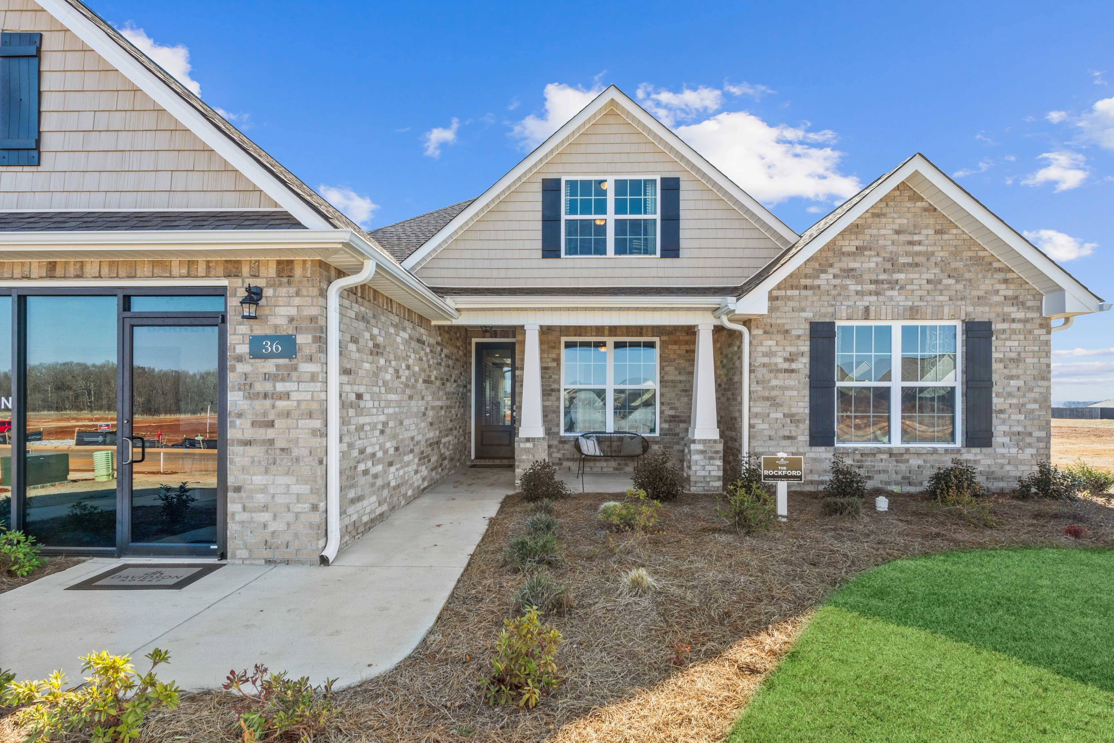 Craftsman-style home exterior at Barnett's Crossing in Madison, Alabama with brick base, shake gables, and covered front porch