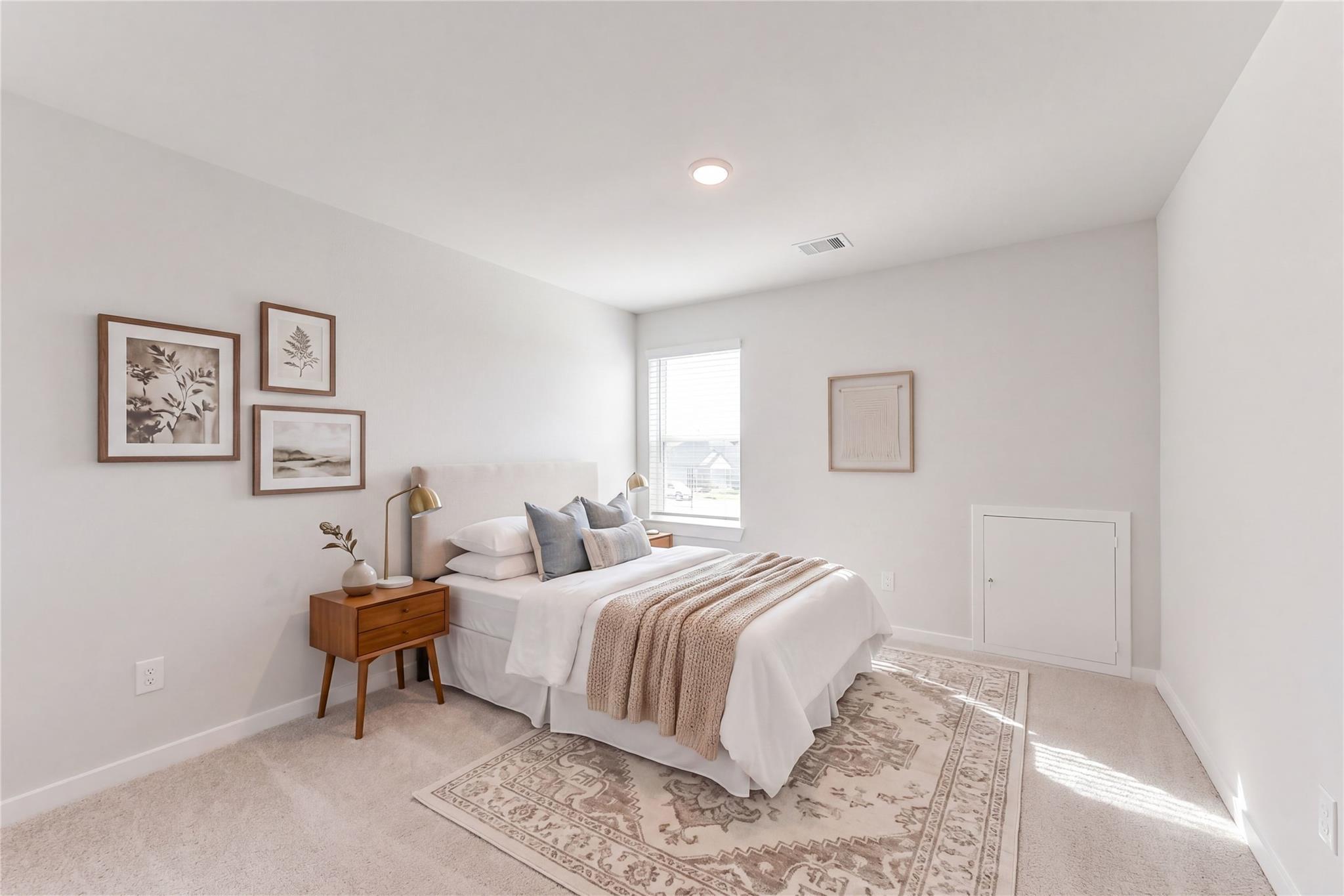 Serene secondary bedroom with white queen bed, beige throw, wooden nightstand, and botanical wall art in Davidson Homes Sabine F, Dayton Texas