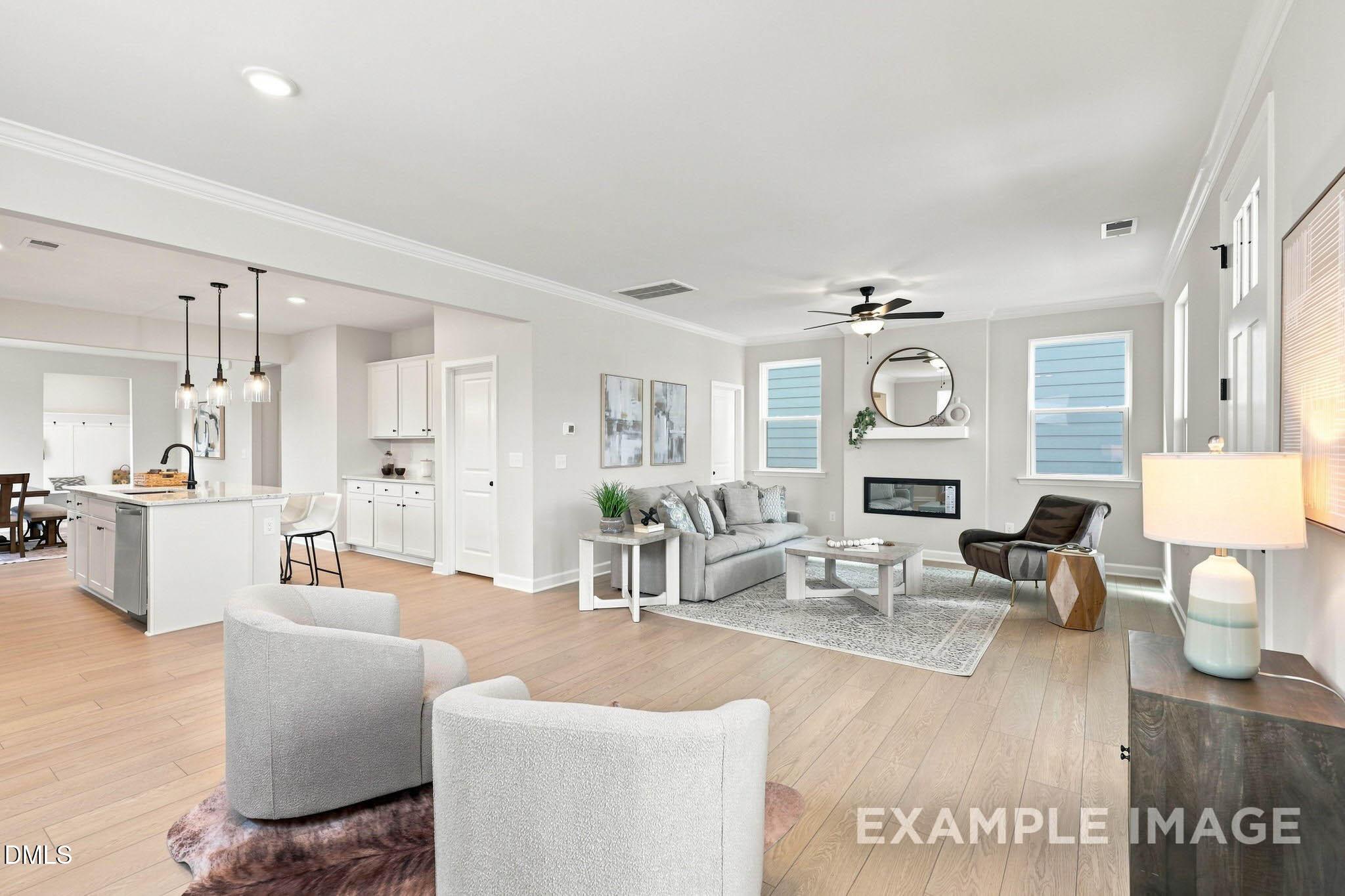 Bright open-concept living room and kitchen with fireplace and hardwood floors in Davidson Homes' Harris A plan, Knightdale, NC