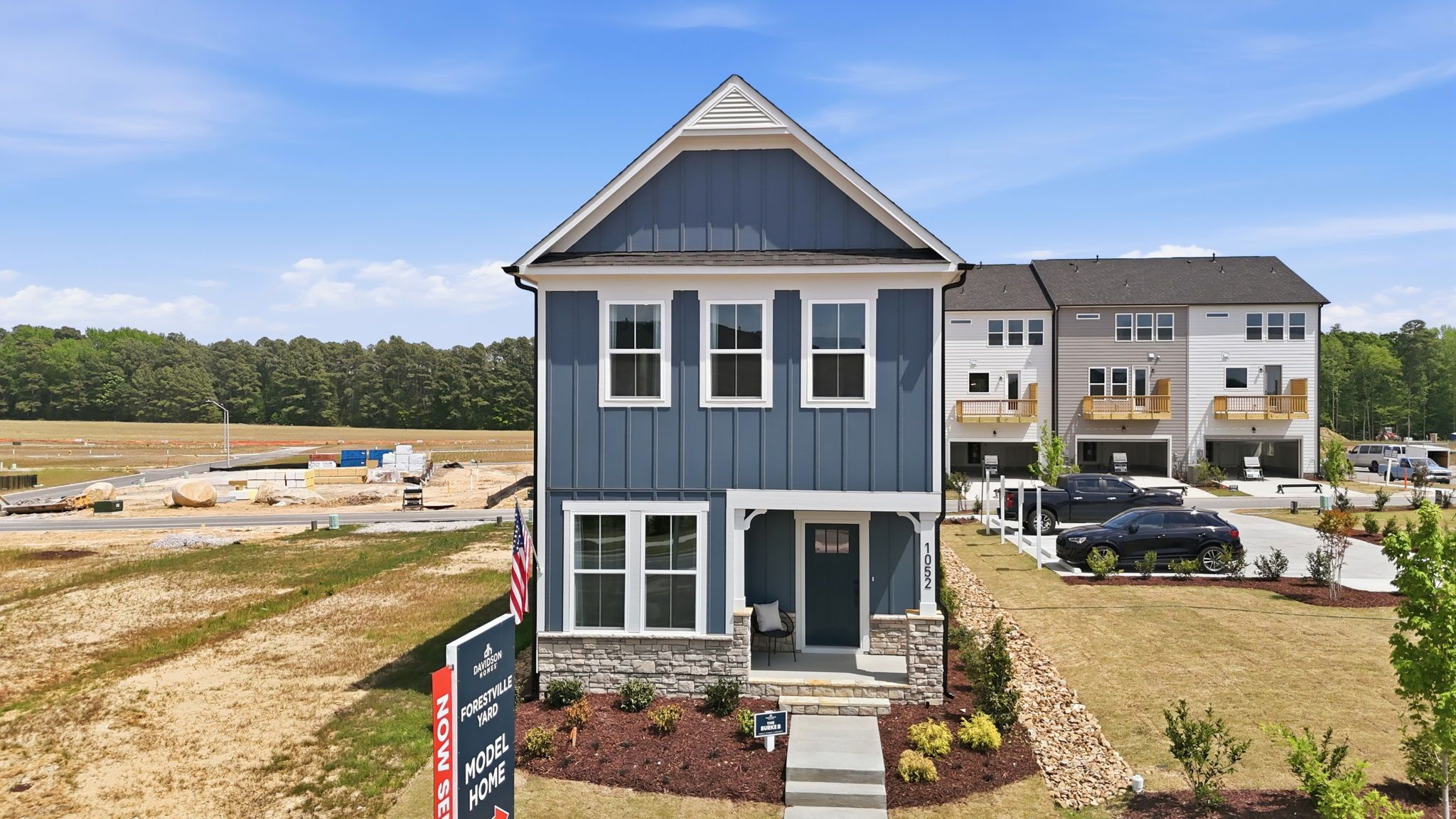 The Burke 2-story single-family home by Davidson Homes in Knightdale, NC, featuring blue siding and stone exterior.