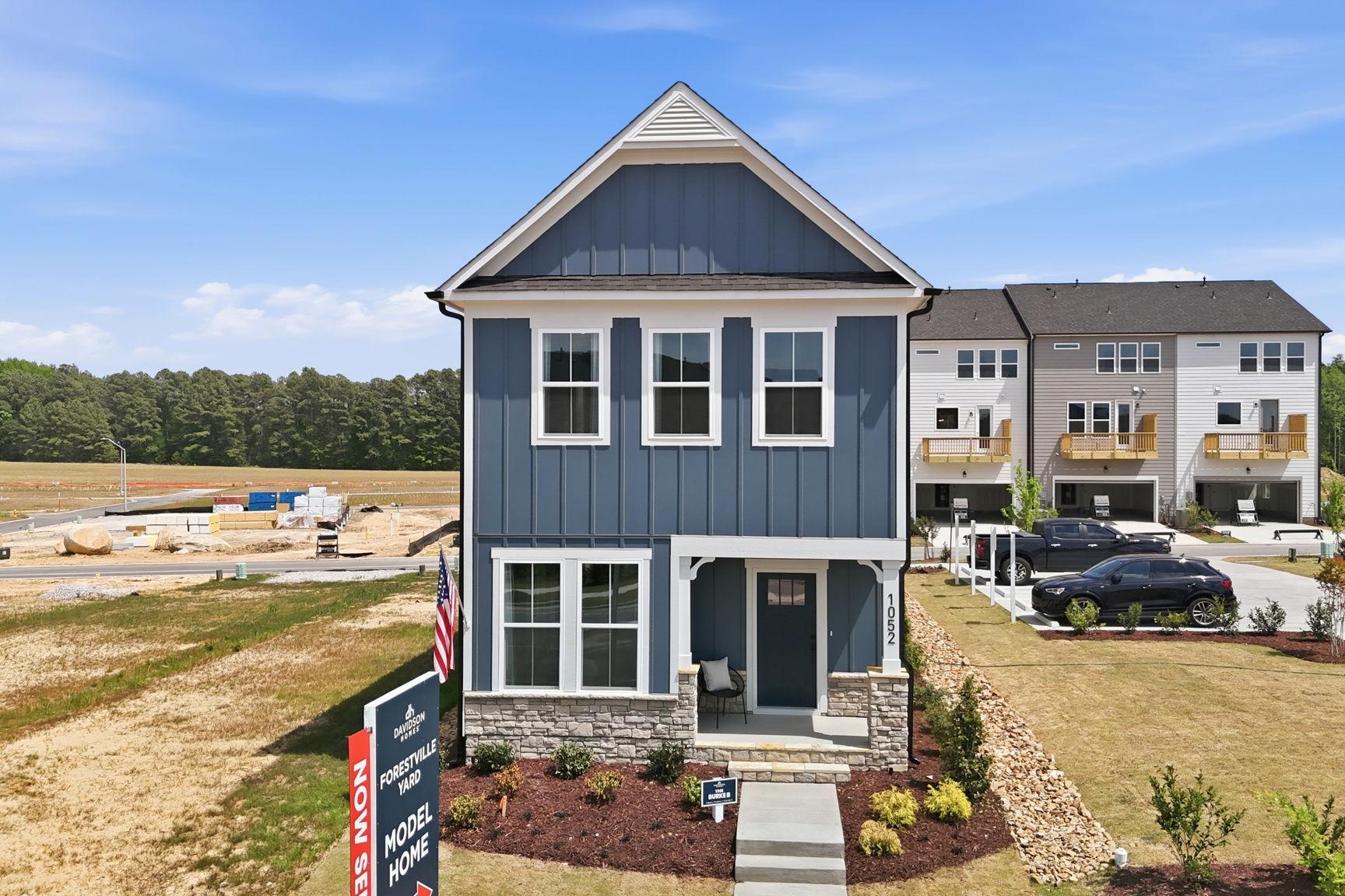 The Burke 2-story single-family home by Davidson Homes in Knightdale, NC, featuring blue siding and stone exterior.