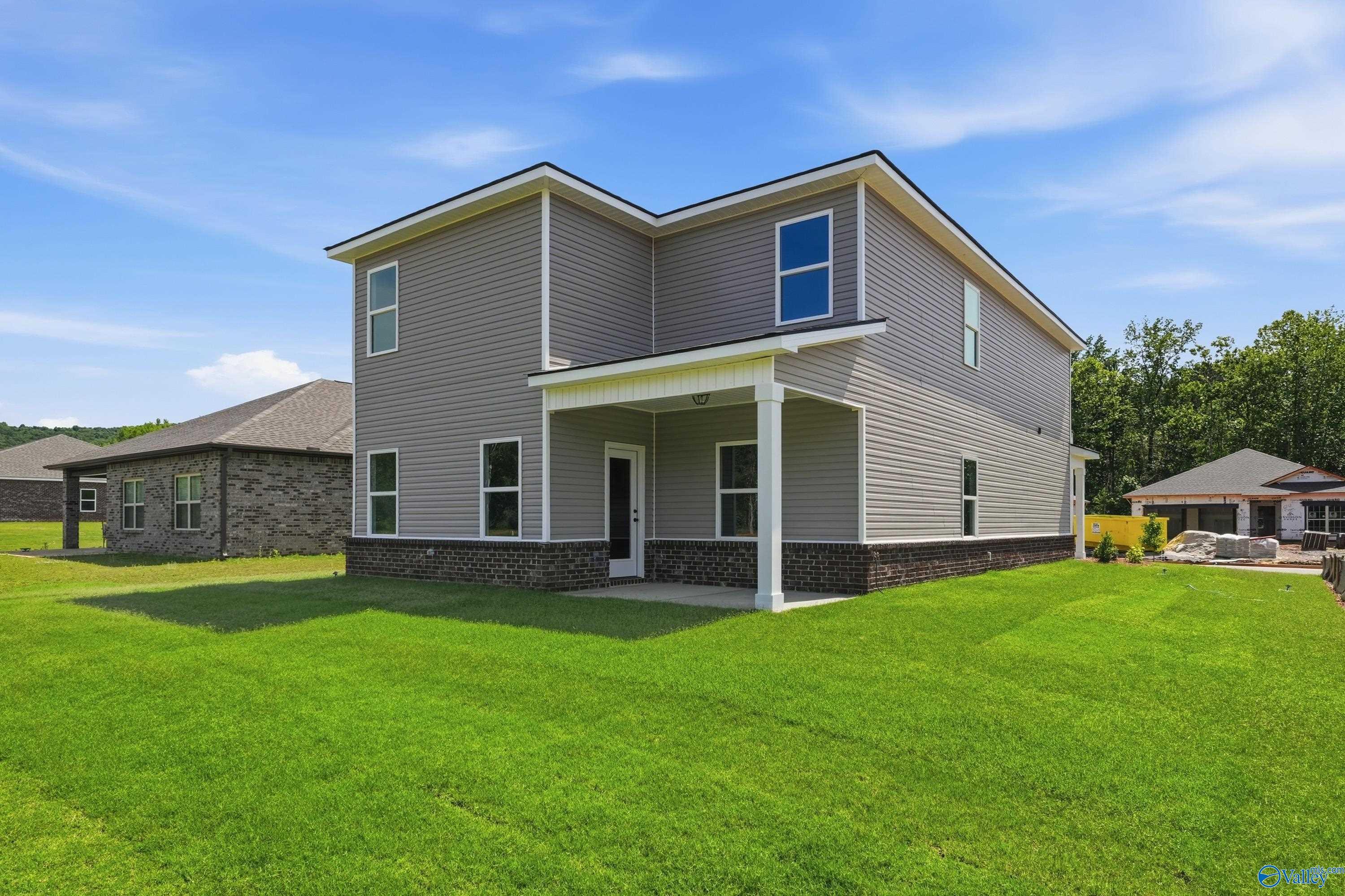 Rear view of Davidson Homes The Russell A floor plan with covered patio in Spragins Cove, Huntsville, Alabama.