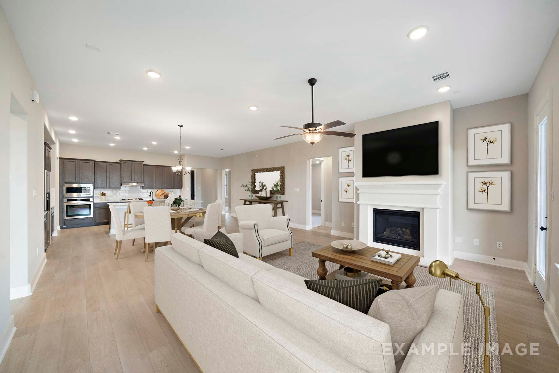 Open-concept living area in The Elizabeth by Davidson Homes featuring fireplace, gourmet kitchen, and dining space in Texas City.