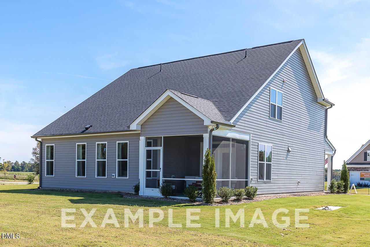 Rear exterior of gray two-story Davidson Homes Ash C plan with screened porch and landscaped yard in Retreat at North Main, Lillington NC