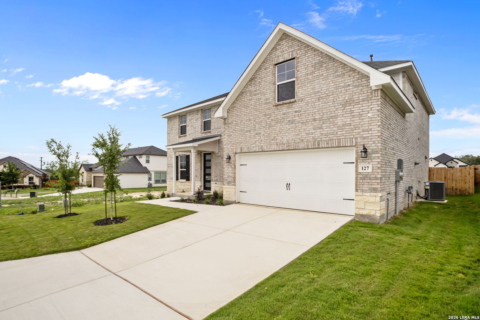 Two-story Danbury H floor plan by Davidson Homes with brick exterior and 2-car garage in The Reserve at Potranco Oaks.