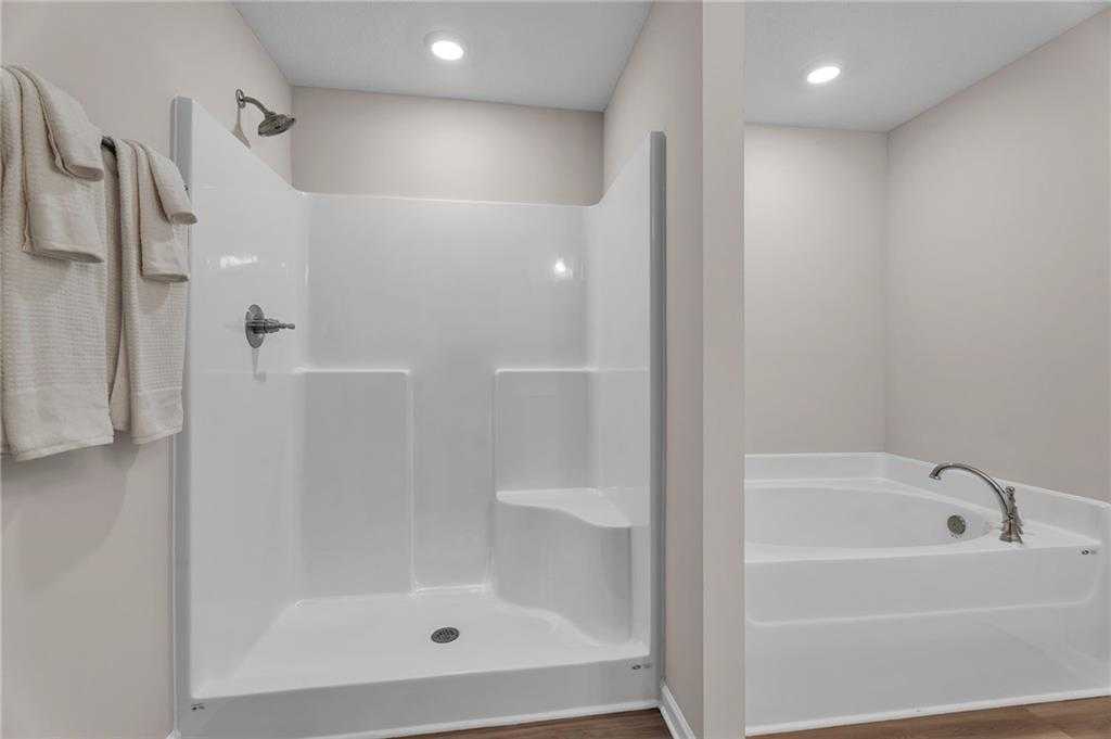 Modern master bathroom with walk-in shower bench and soaking tub in Davidson Homes The Bartlett, Phenix City, Alabama
