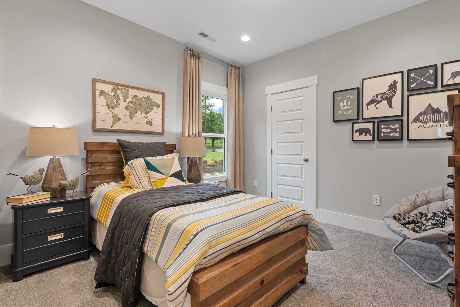 Rustic boy's bedroom at Monteagle Cove in Owens Cross Roads AL with wooden bed, world map art, and gray walls