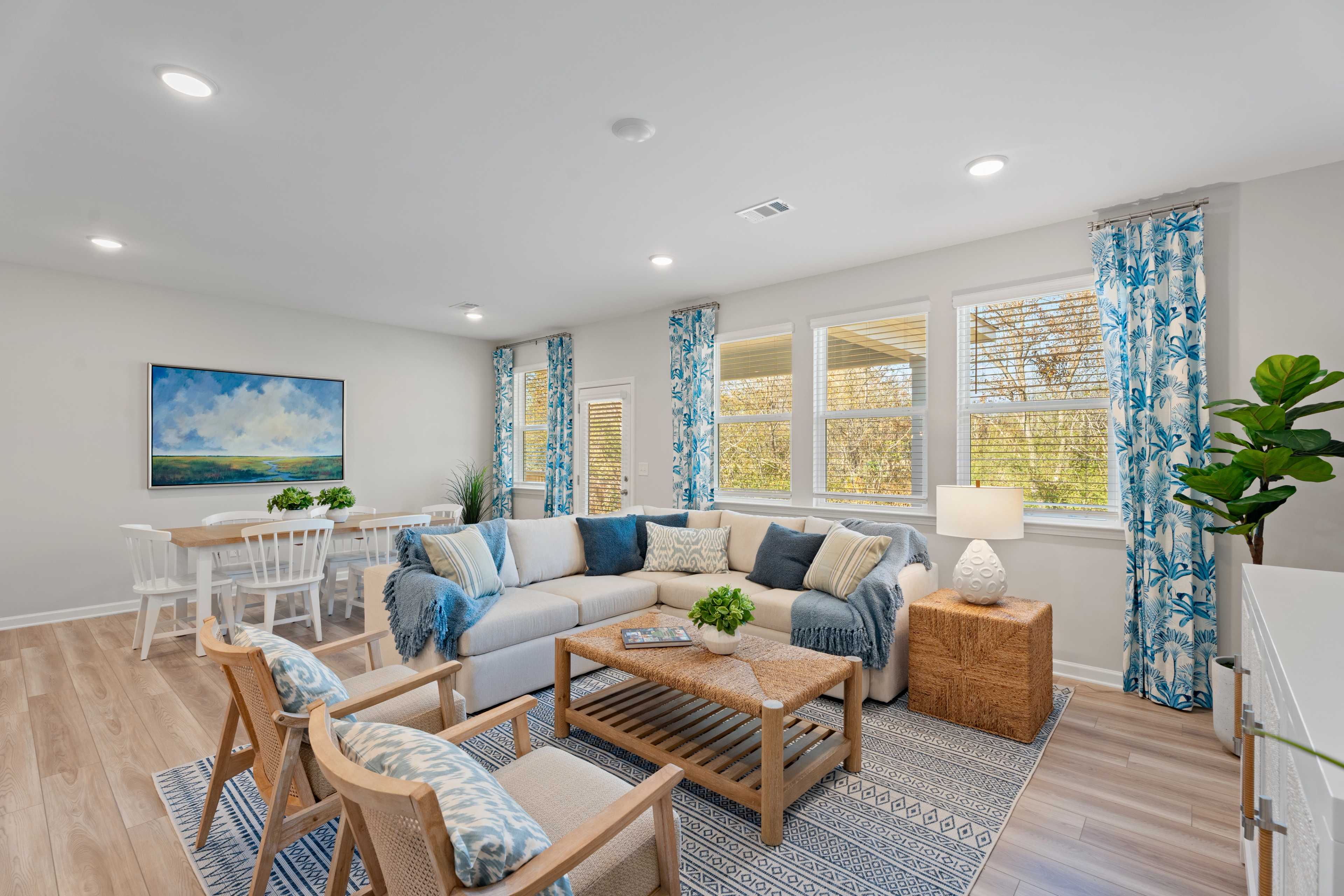 Decorated Living room with big beige sectional, coffee table and 2 chairs