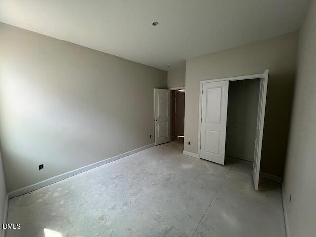 Spacious master bedroom with open walk-in closet and neutral beige walls in The Preston A, Lillington, NC