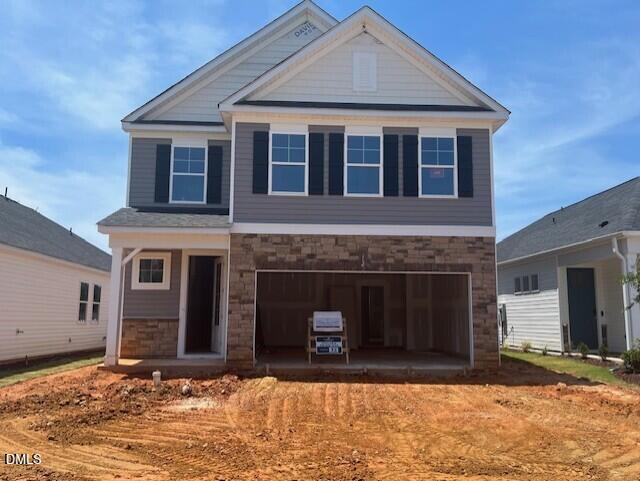 Two-story Gavin C floor plan by Davidson Homes with stone facade and two-car garage in Gregory Village, Lillington, NC.