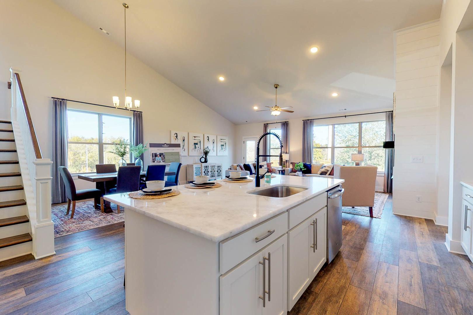 Spacious open-concept kitchen and dining at Liberty Creek in Gallatin TN with white island, hardwood floors, large windows