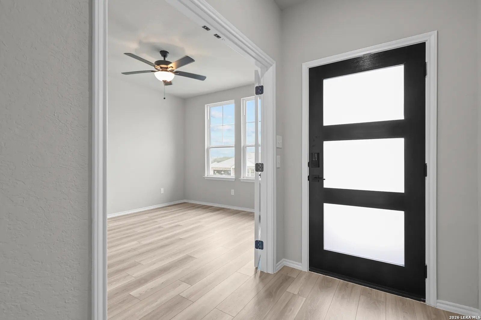 Modern home office with French doors and wood-look floors in The Glenwood E floor plan at Comanche Ridge, San Antonio.