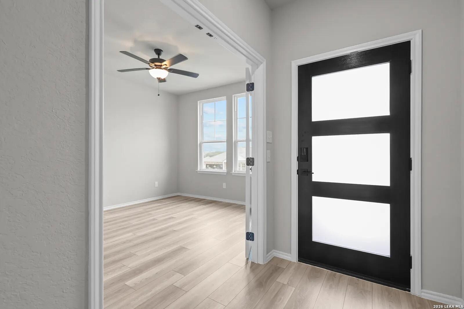 Modern home office with French doors and wood-look floors in The Glenwood E floor plan at Comanche Ridge, San Antonio.