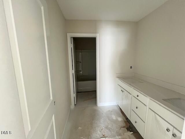 White vanity with sink, bathtub-shower combo in secondary bath of Davidson Homes The Preston A, Lillington, NC