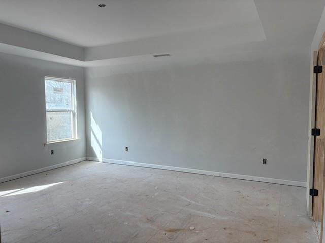 Empty bedroom with tray ceiling, light gray walls, large window and double doors in Davidson Homes The Hickory B, Winder, Georgia