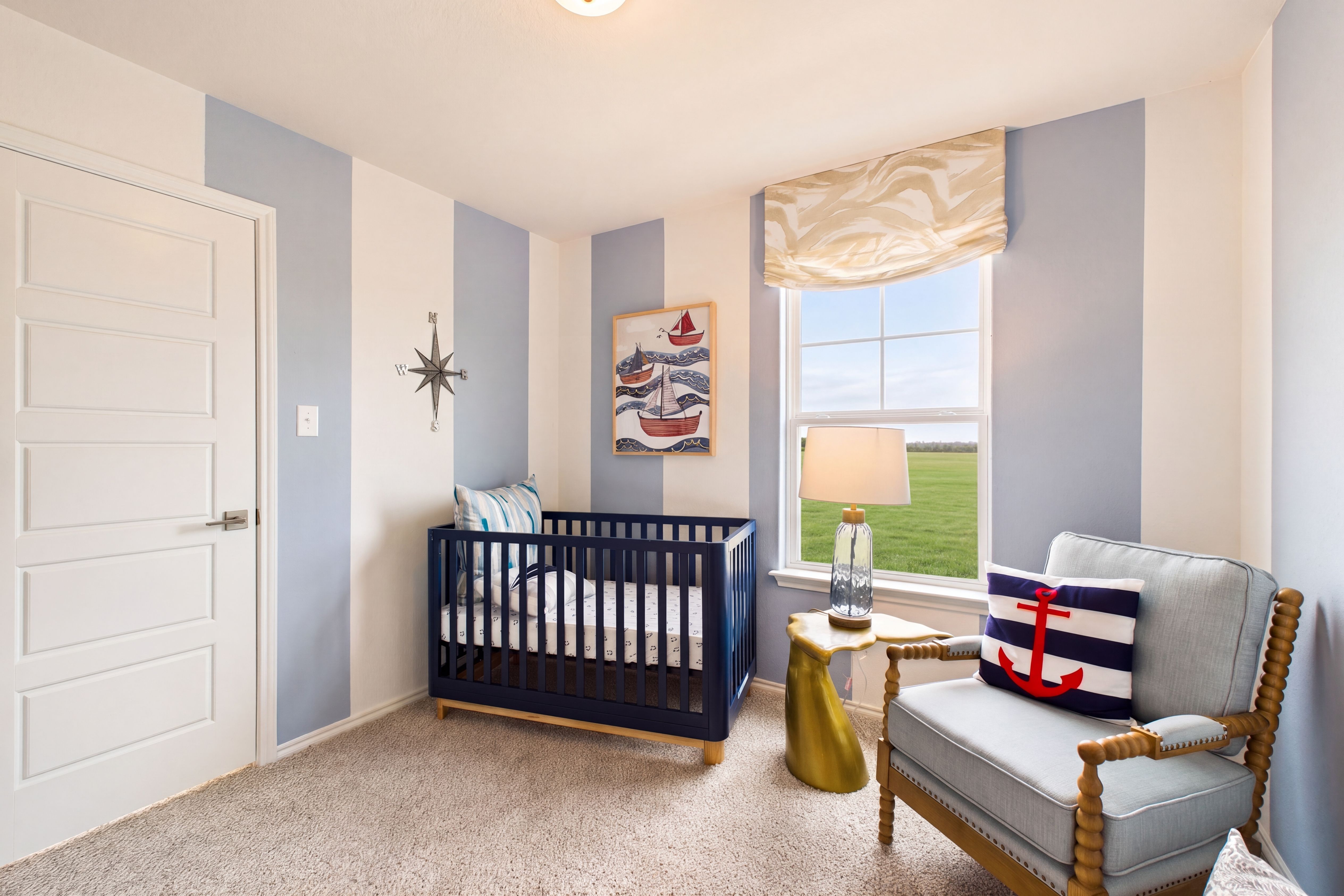 Spacious bedroom with large window located in the model home in San Antonio, TX