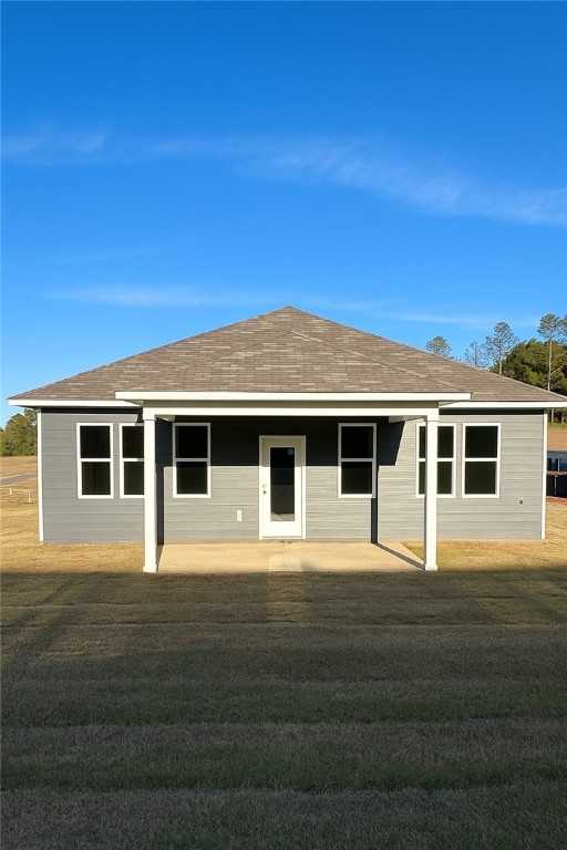 Modern gray single-story home with covered front porch, windows, and shingled roof in Anderson Lakes, Opelika, Alabama by Davidson Homes