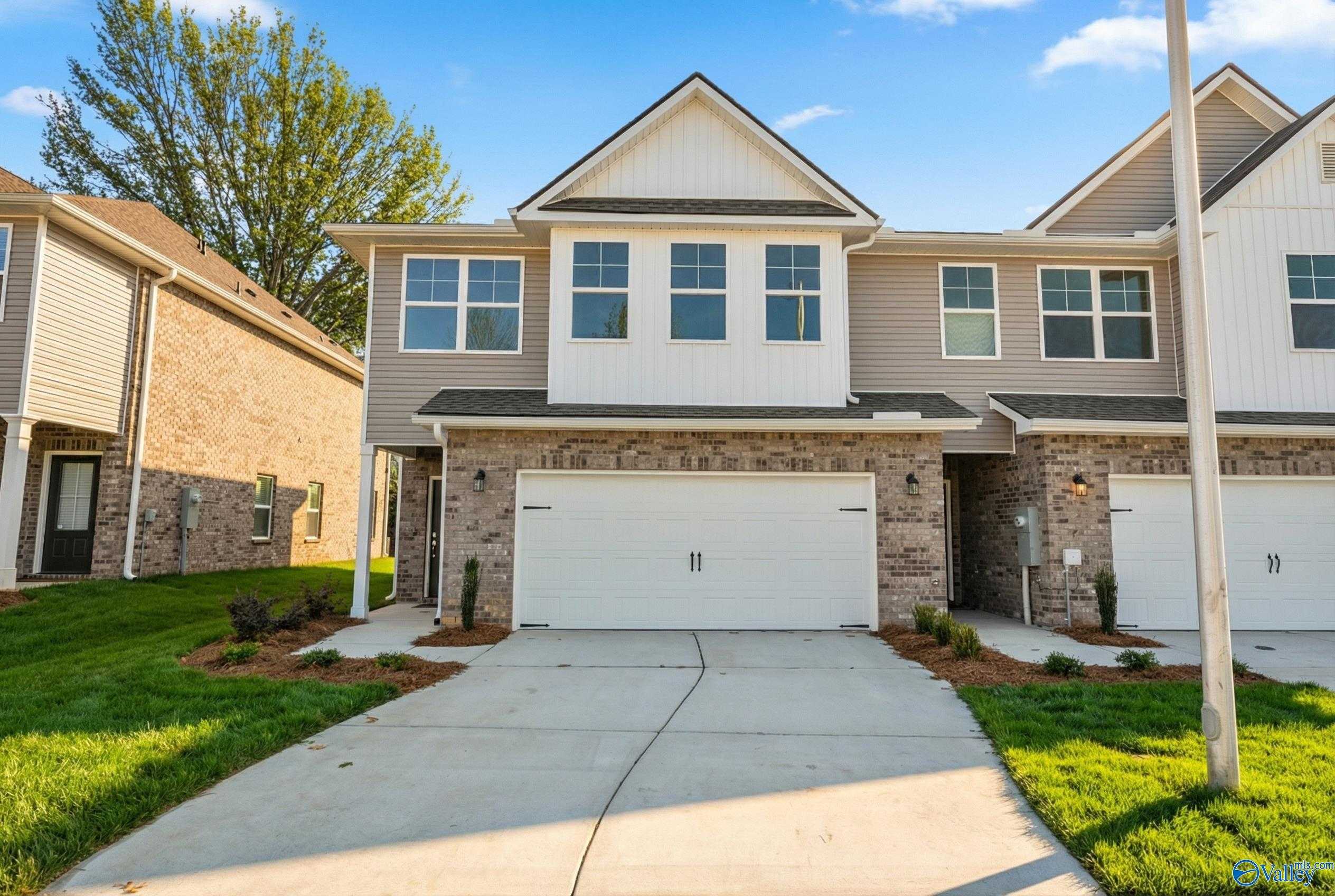 Modern two-story Camden home exterior with two-car garage, driveway, and landscaped yard in Pavilion, Huntsville, Alabama