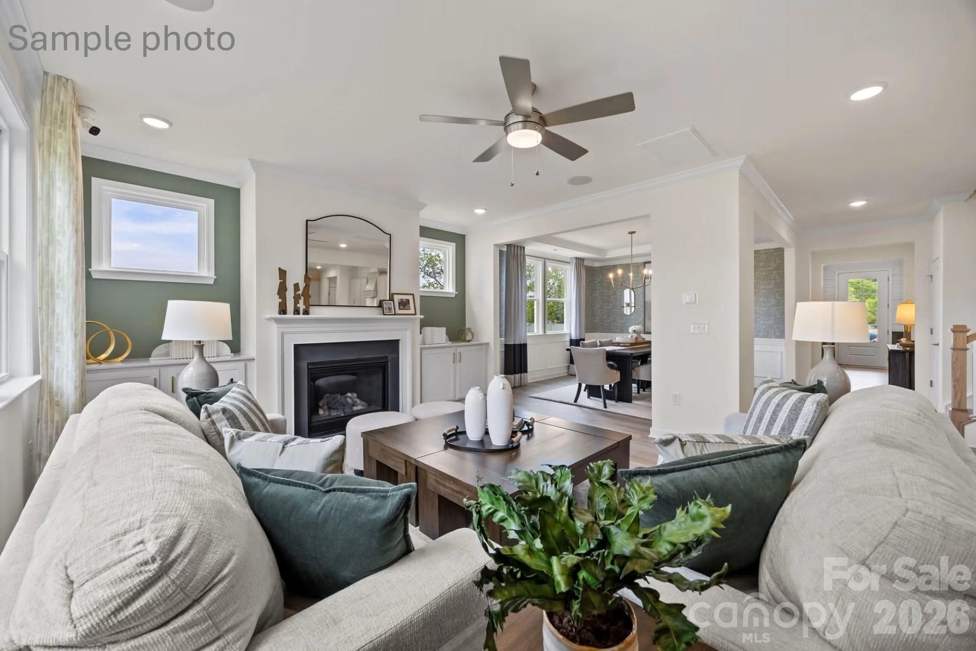 Open-concept living room with fireplace in The Beech B floor plan at Enclave at Belmont in Belmont, North Carolina.