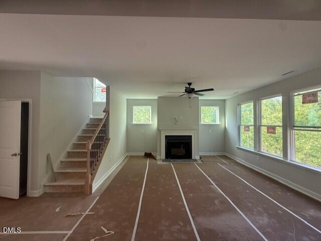 Open living room with fireplace and staircase in The Chestnut floor plan by Davidson Homes in Montrose, Aberdeen, NC.
