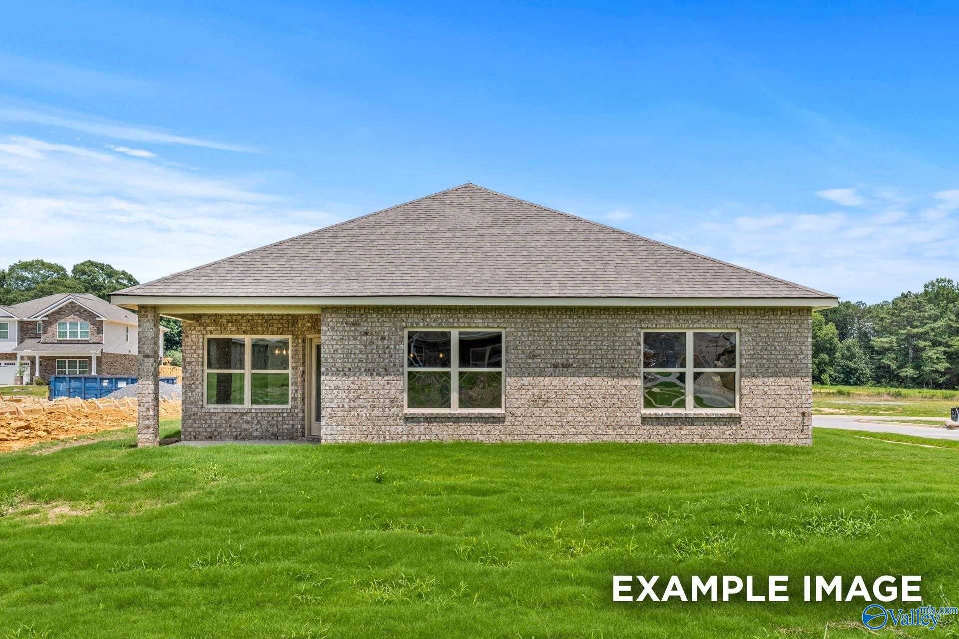 Modern brick 1-story 4-bedroom home with 2-car garage, lush green lawn in The Highlands, Arab, Alabama by Davidson Homes