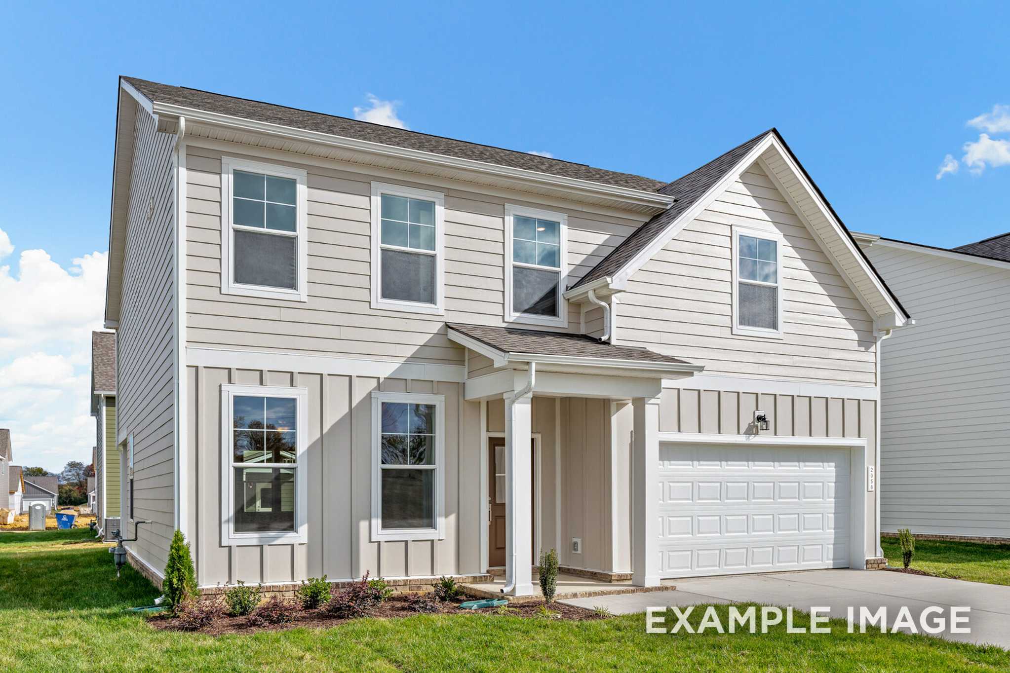 Two-story Murray A home elevation by Davidson Homes: beige siding, dark roof, columned porch, two-car garage, landscaped yard in White House, TN