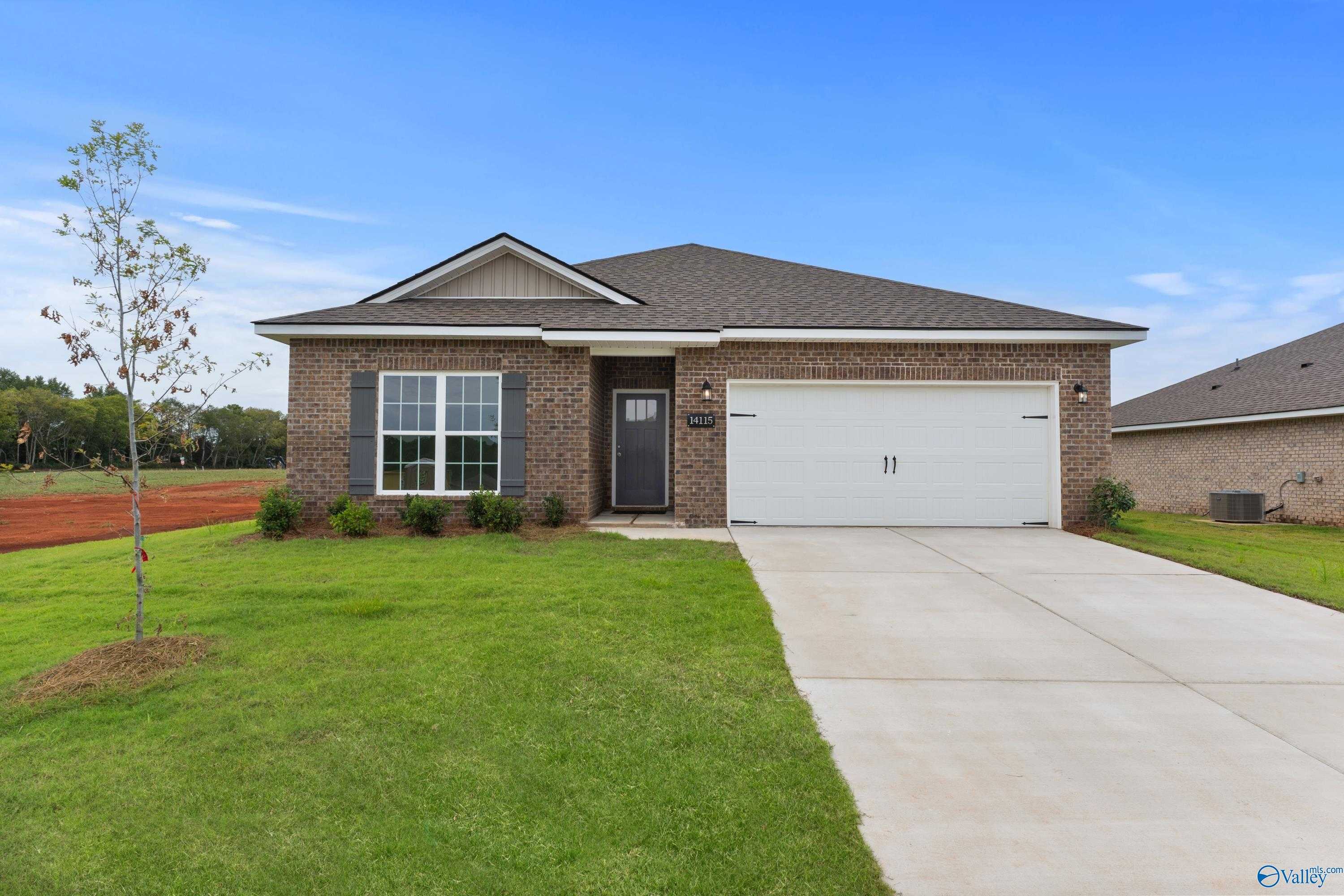 Charming brick single-story 3-bedroom home with 1-car garage, driveway, and green lawn in The Meadows, Athens, Alabama - Davidson Homes The Franklin