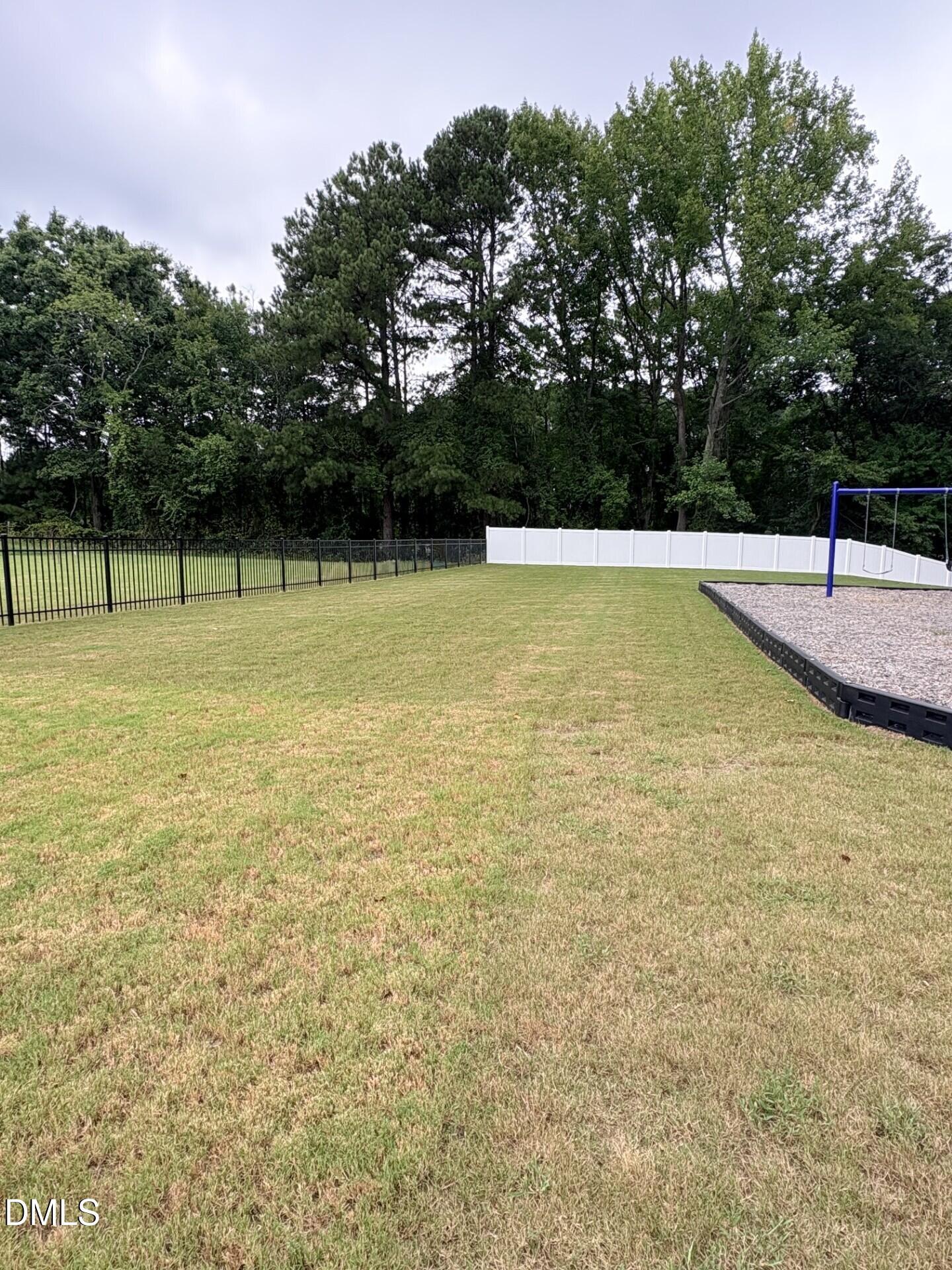Spacious fenced backyard with private playground in Woodland Crossing, Zebulon, North Carolina.