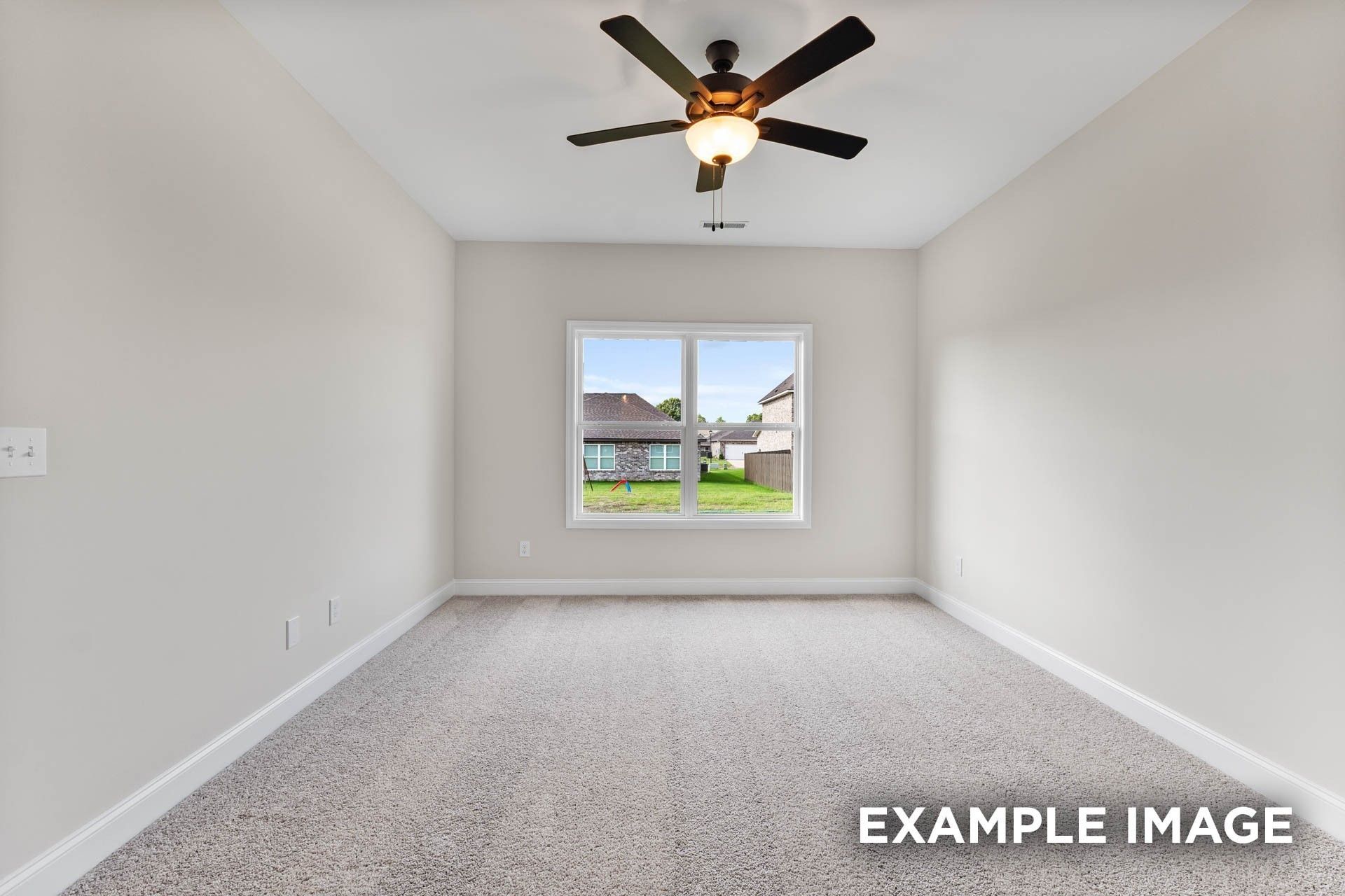 Spacious secondary bedroom with ceiling fan and plush carpeting in The Franklin E floor plan at Bailey Park, Fayetteville.