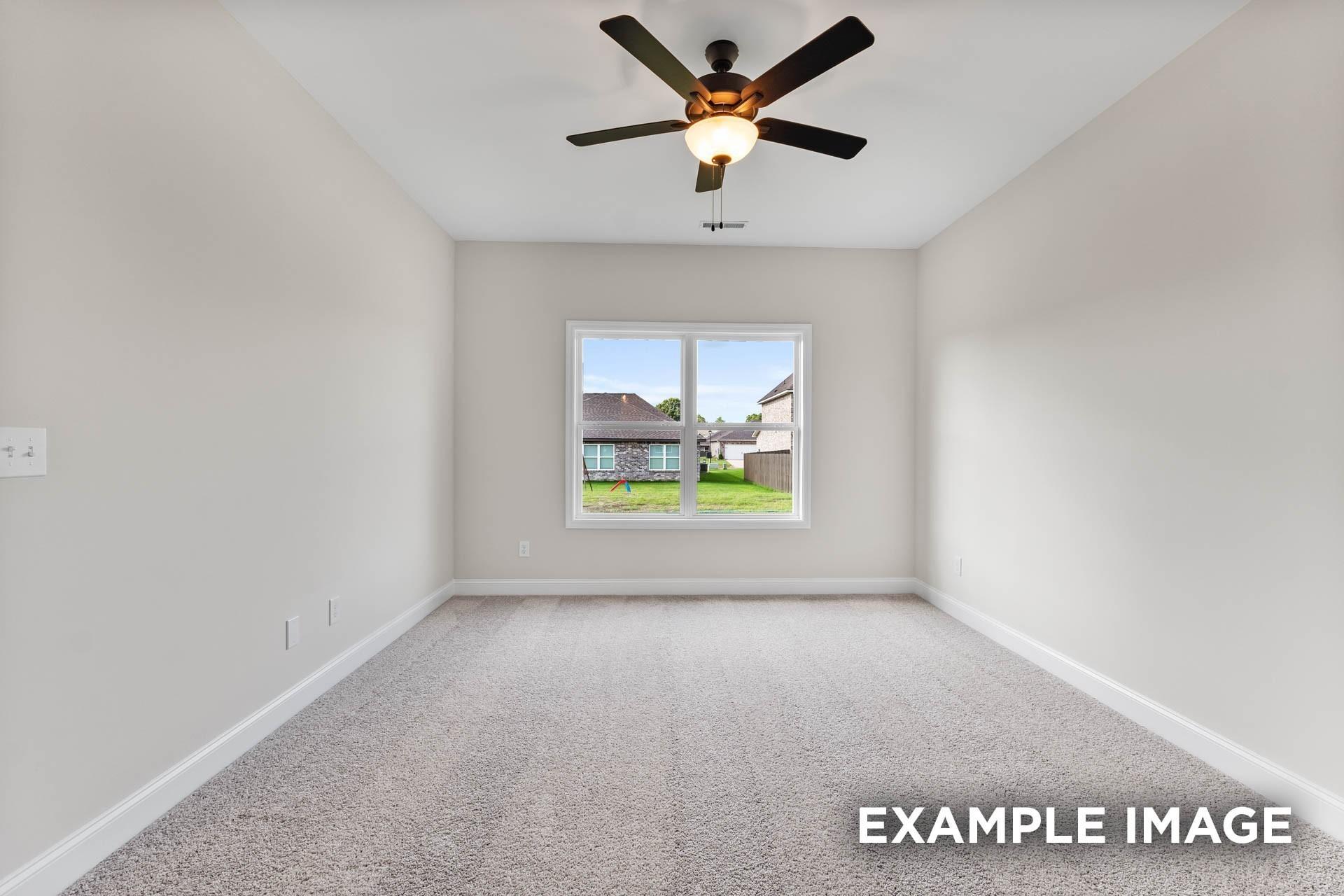 Spacious secondary bedroom with ceiling fan and plush carpeting in The Franklin E floor plan at Bailey Park, Fayetteville.