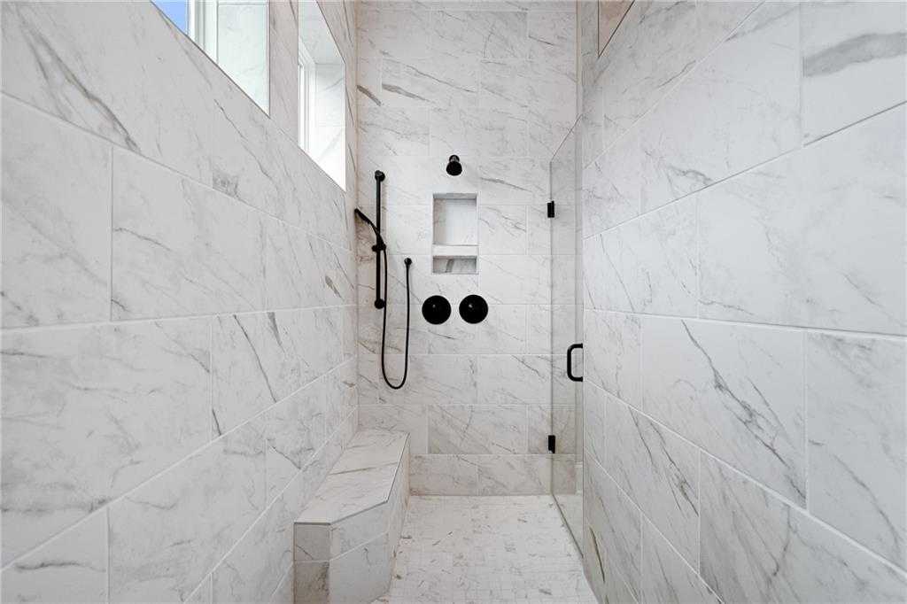 Luxurious white marble walk-in shower with rain head, glass doors, and built-in bench in master bath, Davidson Homes The Seaside B, Woodstock, GA