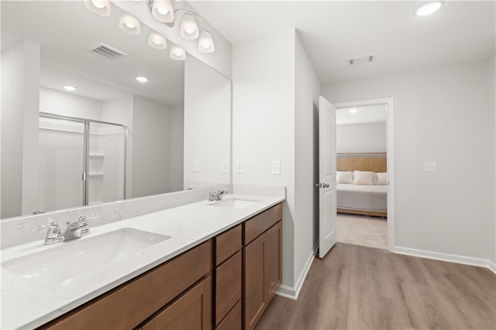 Modern bathroom with double vanity and quartz countertops in The Sinclair B floor plan at Cedar Farms, Winder, Georgia.