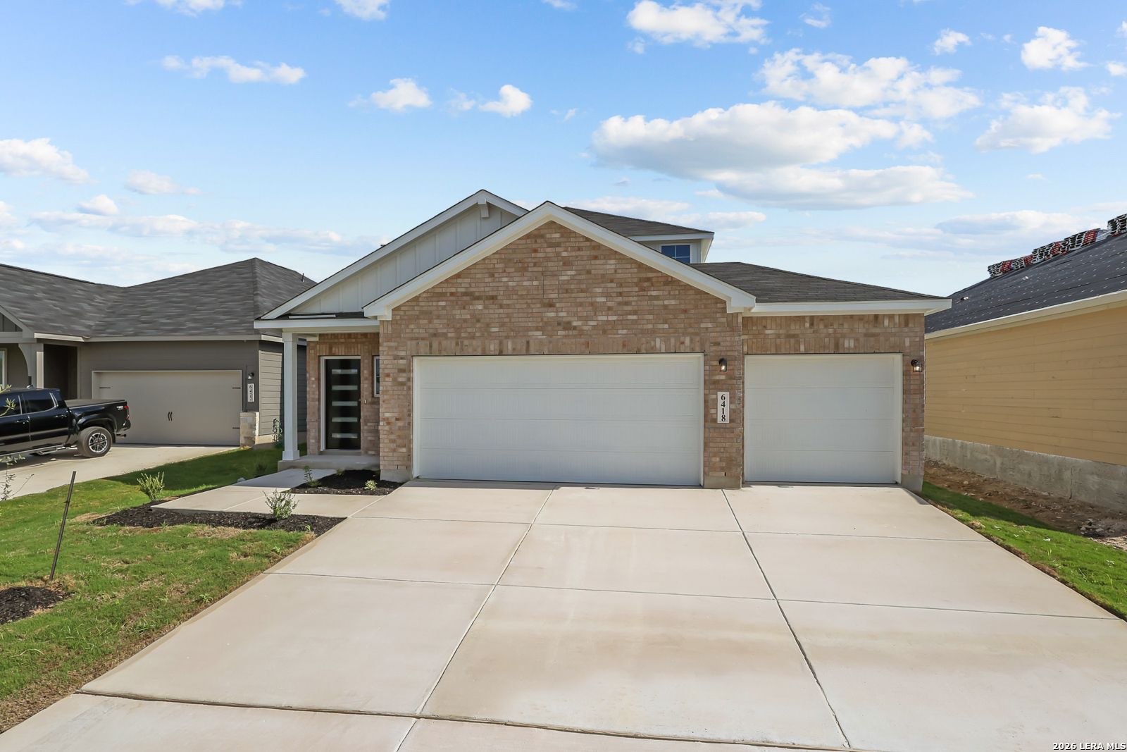 Brick new construction home with 3-car garage and wide driveway in Morgan Meadows, San Antonio, Texas by Davidson Homes