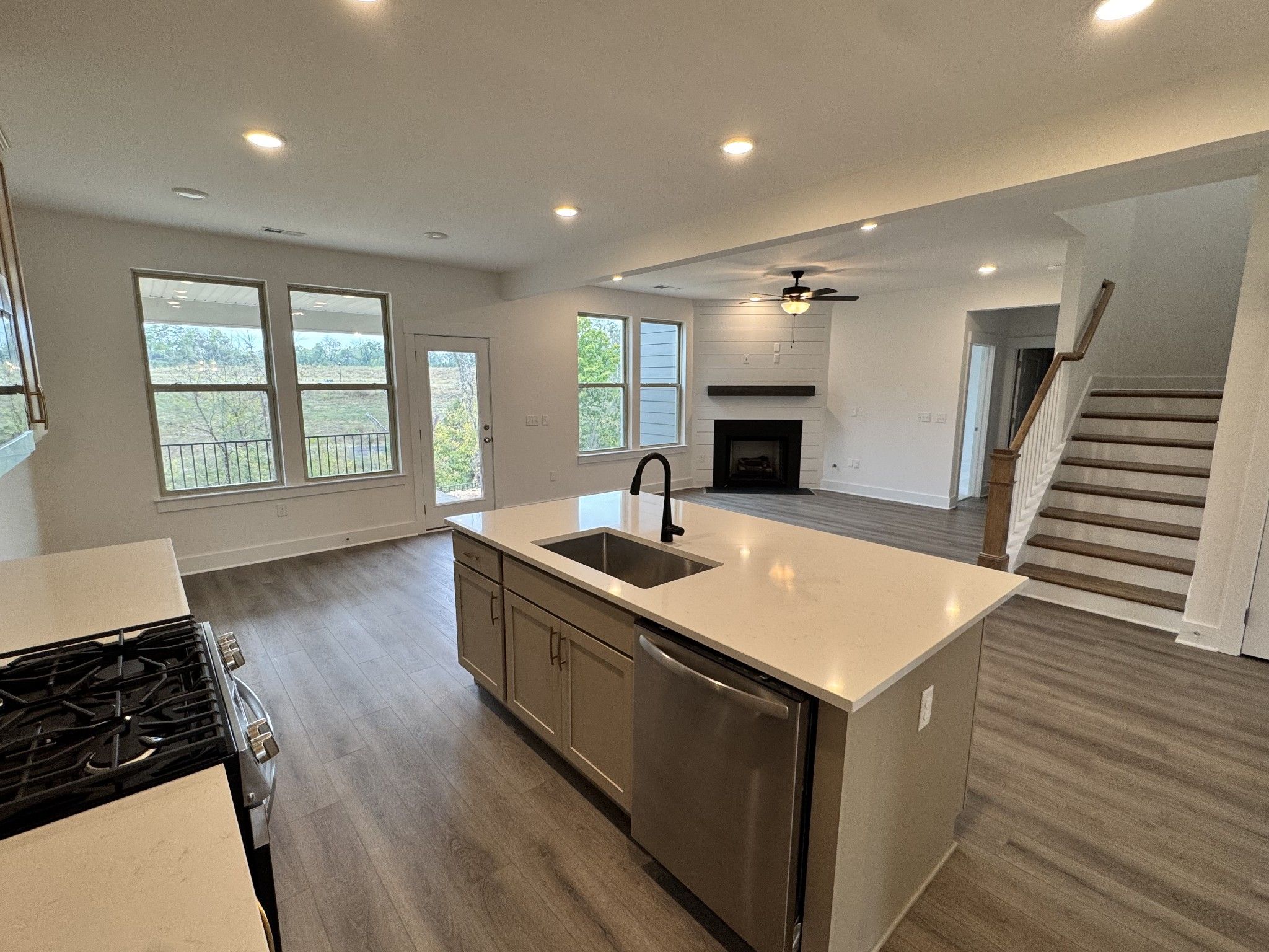 Open-concept kitchen with island sink and great room fireplace in Davidson Homes The Willow B, Woods Crossing, Gallatin TN